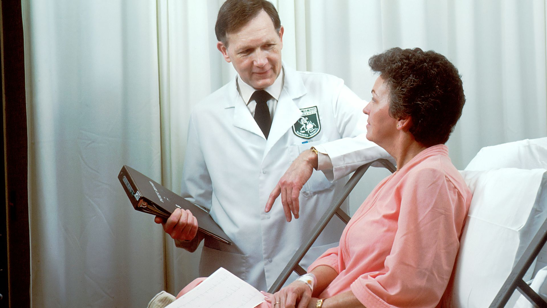 man in white button up shirt holding black tablet computer