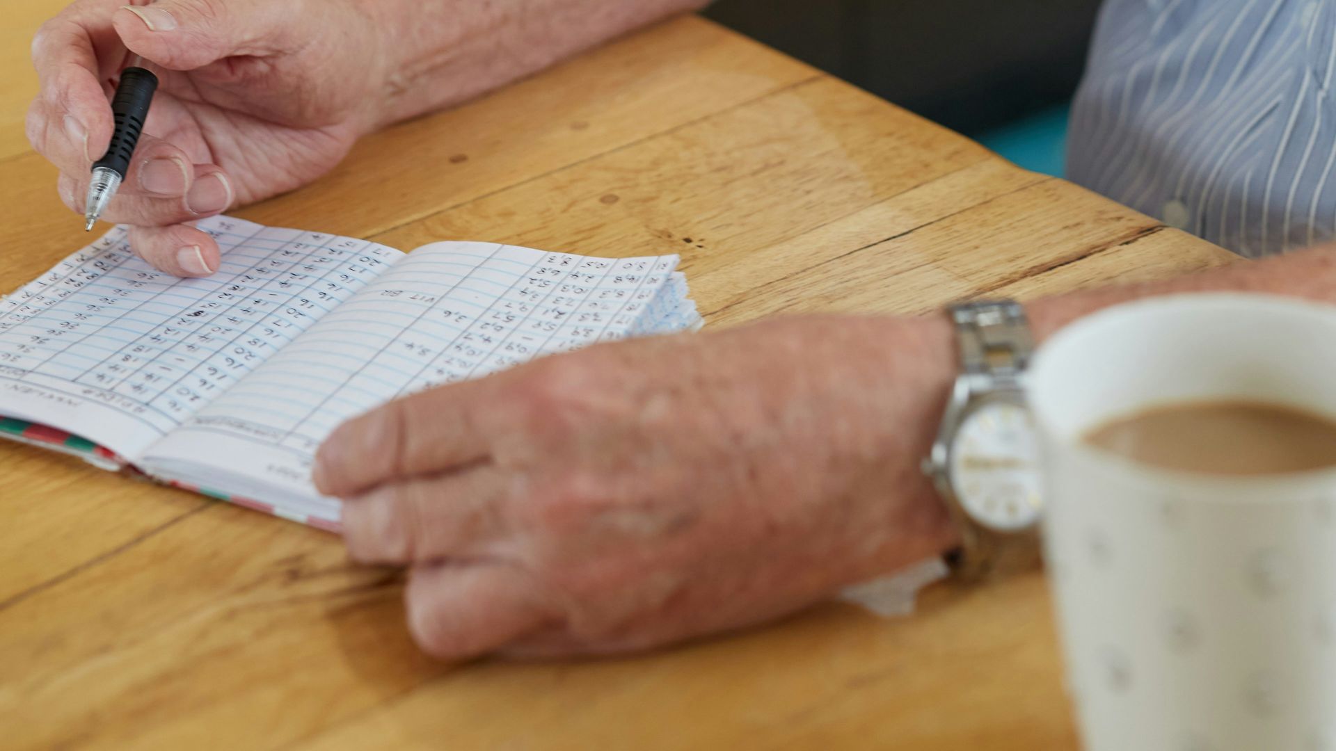 a person writing down blood glucose results