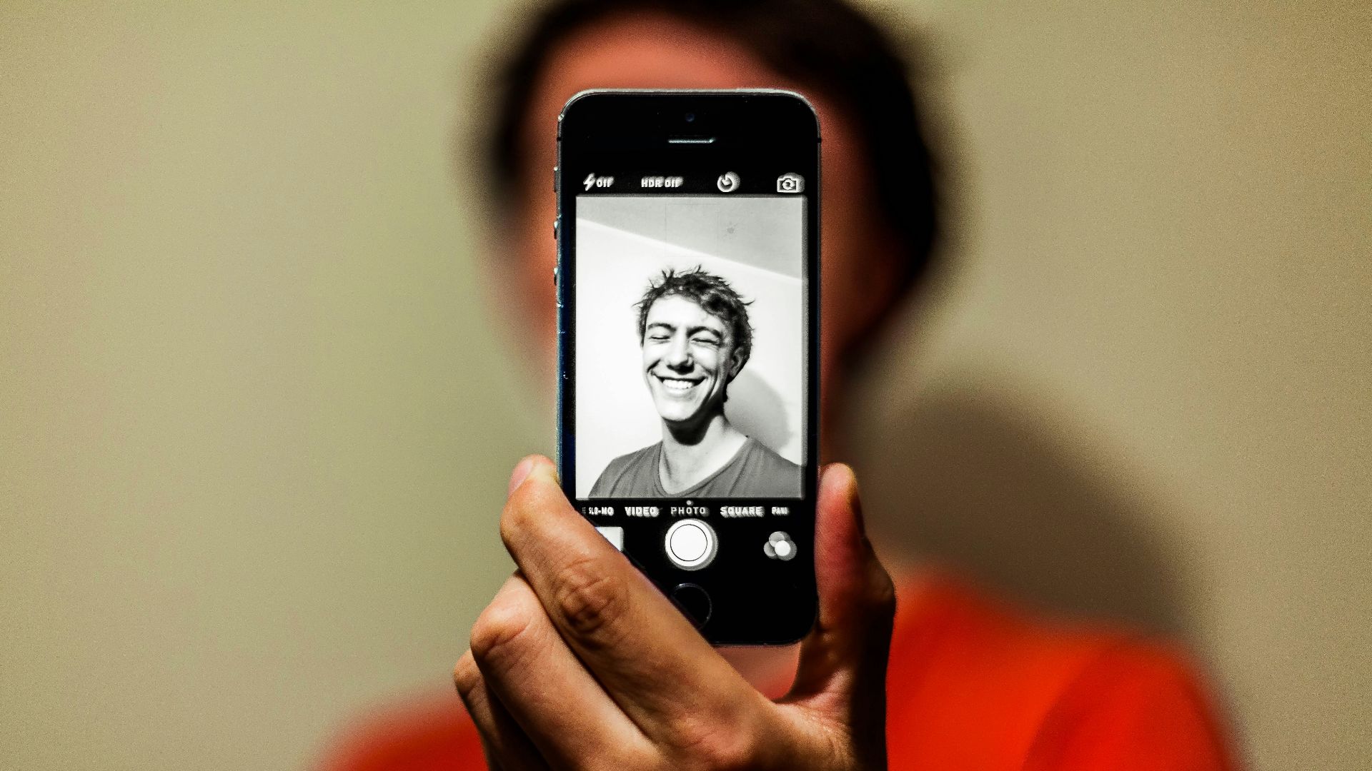 person holding space gray iPhone 5s taking picture