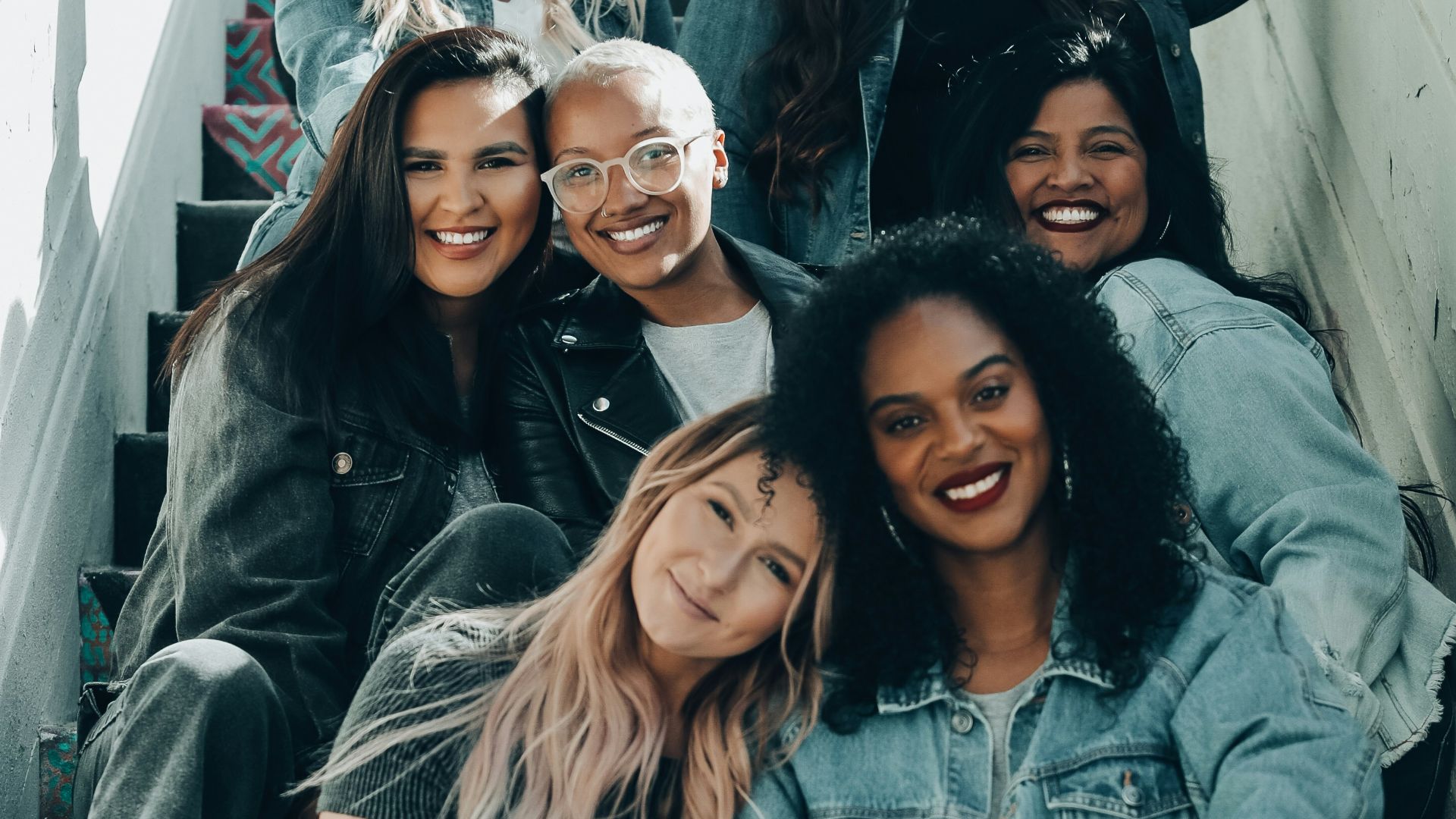2 women sitting on black chair