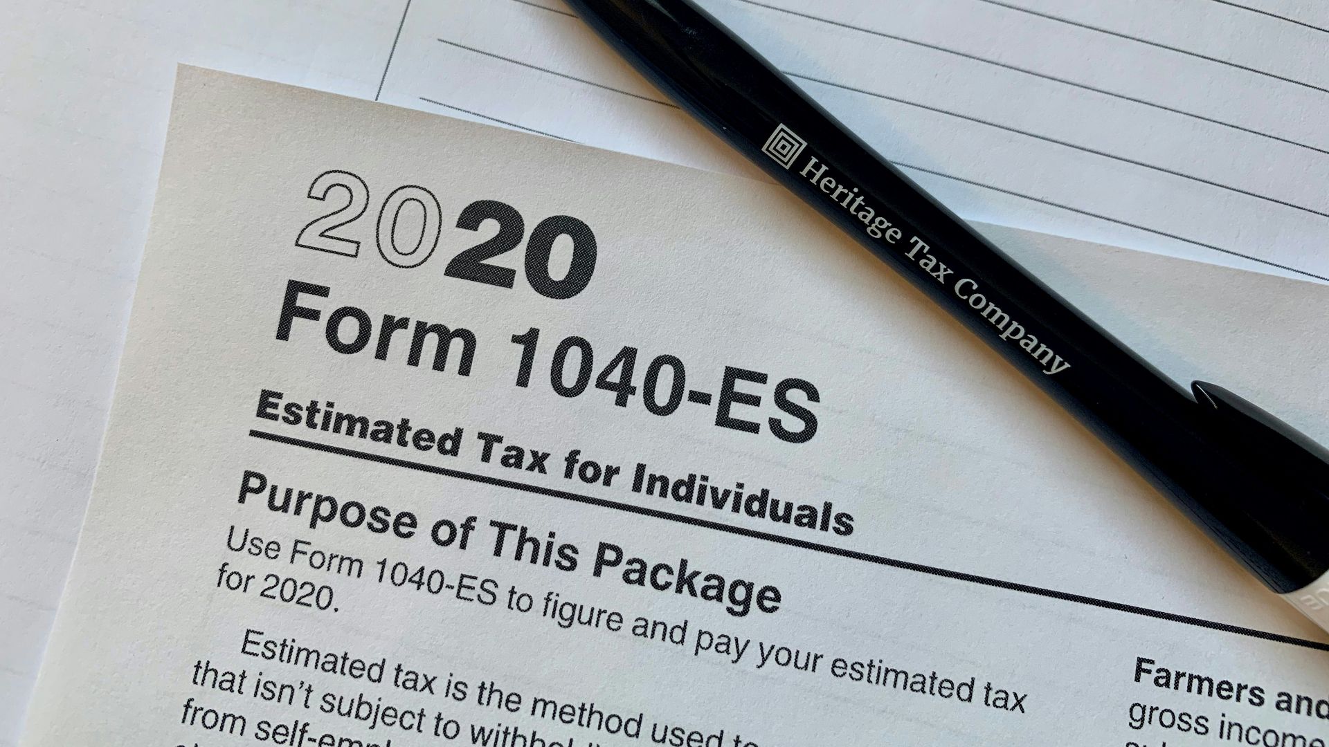 a pen sitting on top of a tax form