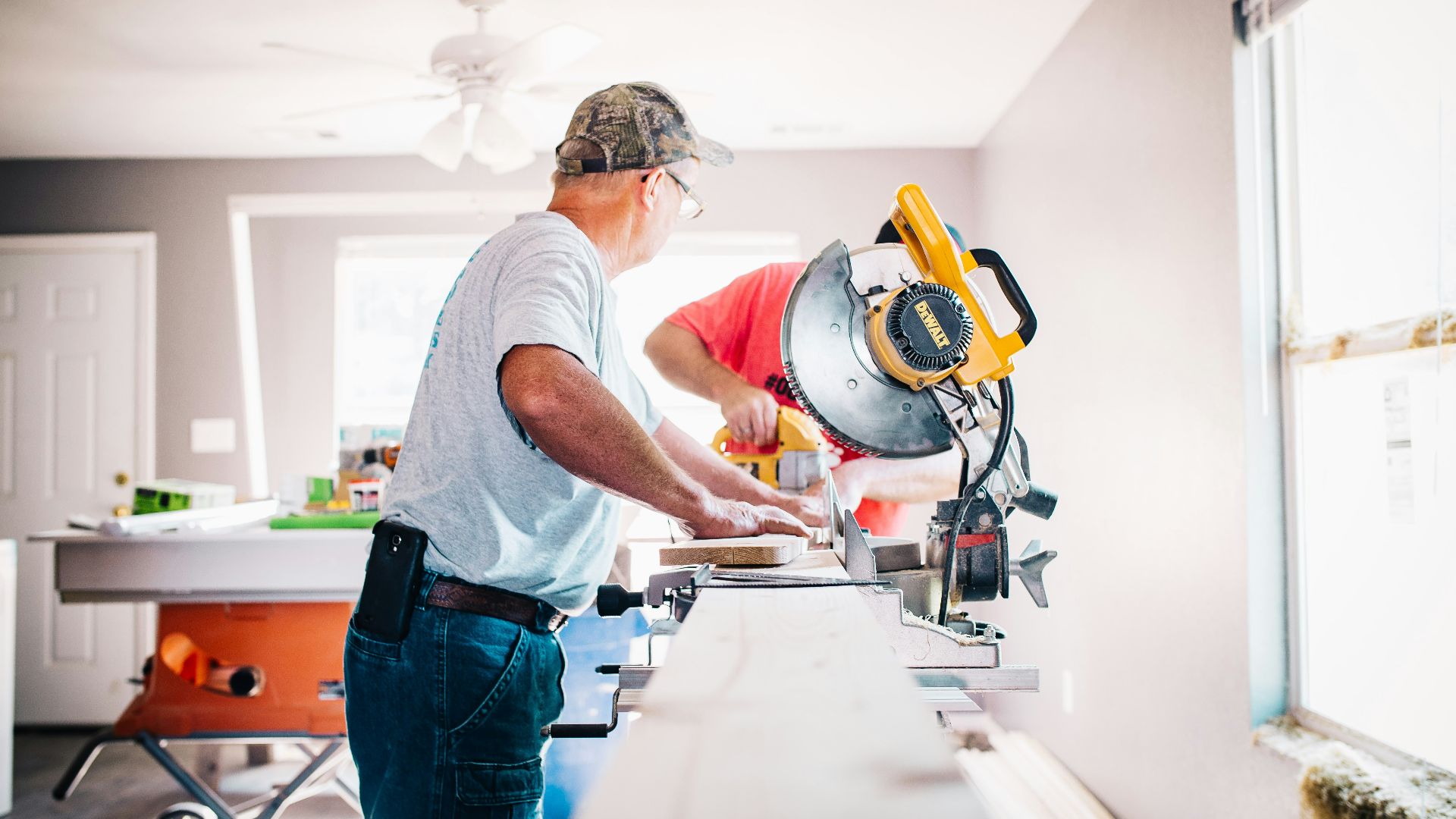 man standing infront of miter saw