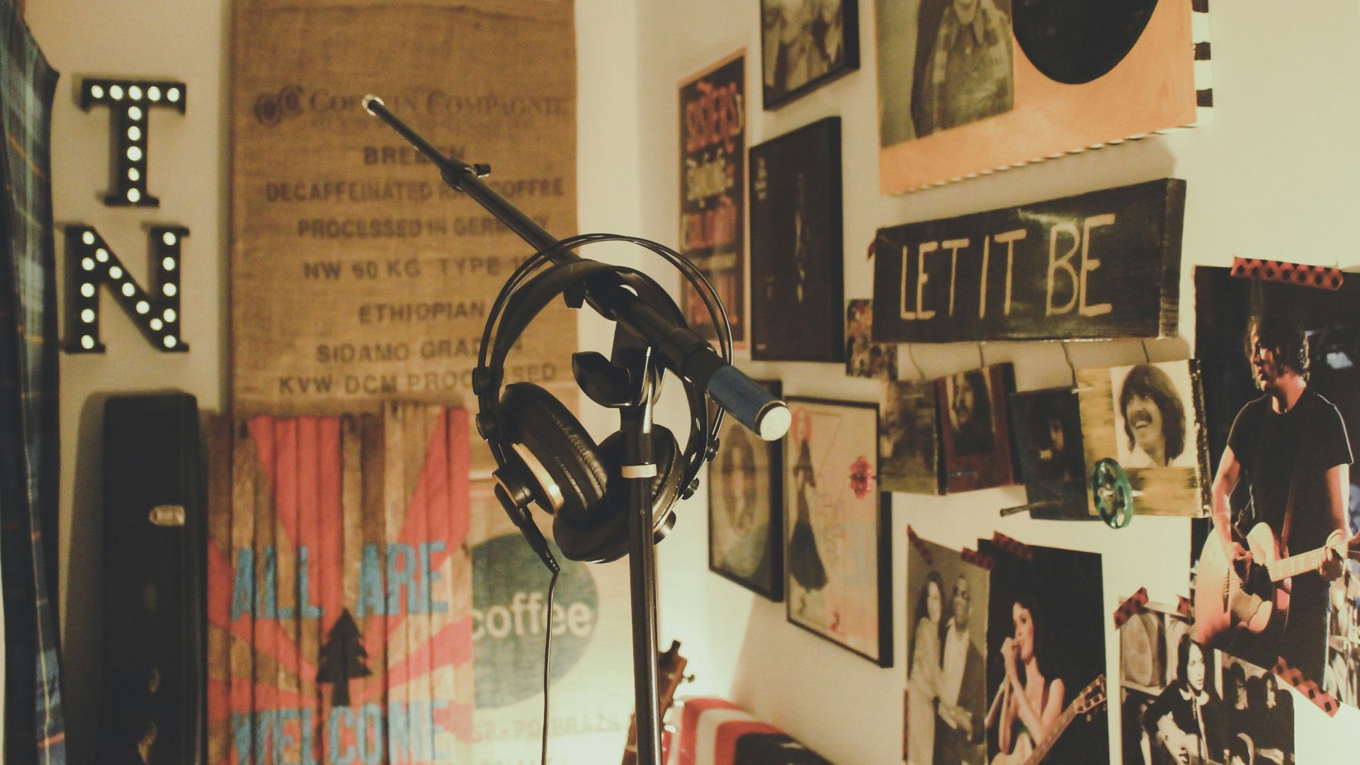 black condenser mic with stand and headphones