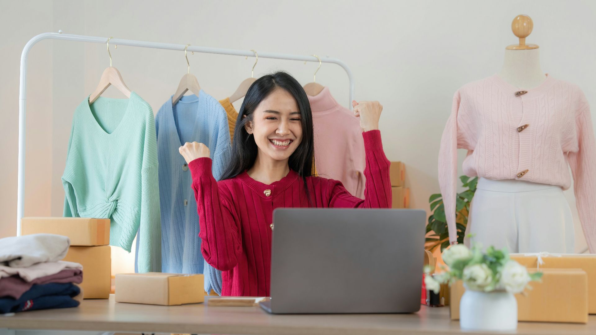 a woman sitting at a desk in front of a laptop computer