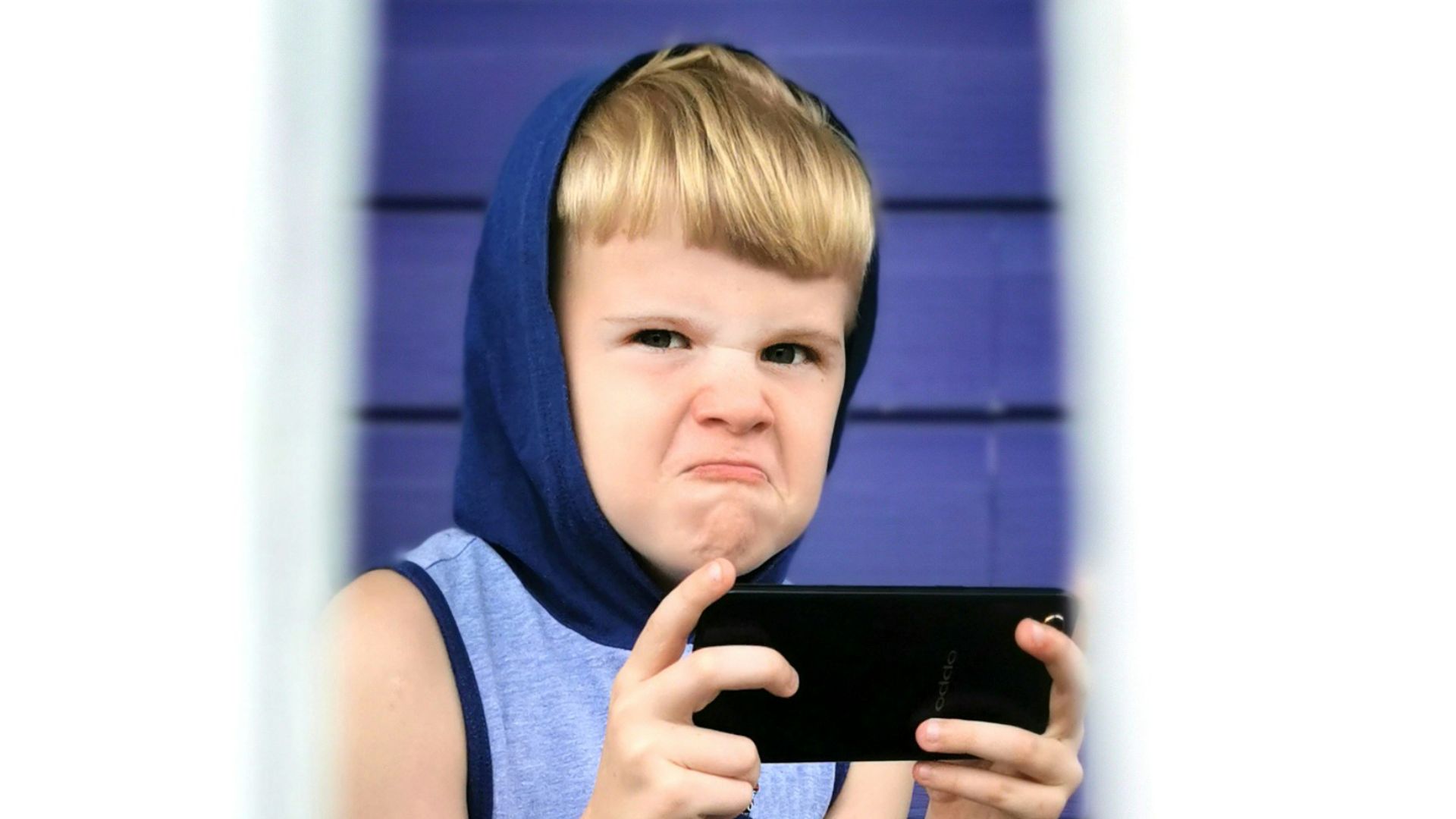 boy in blue tank top sitting on chair