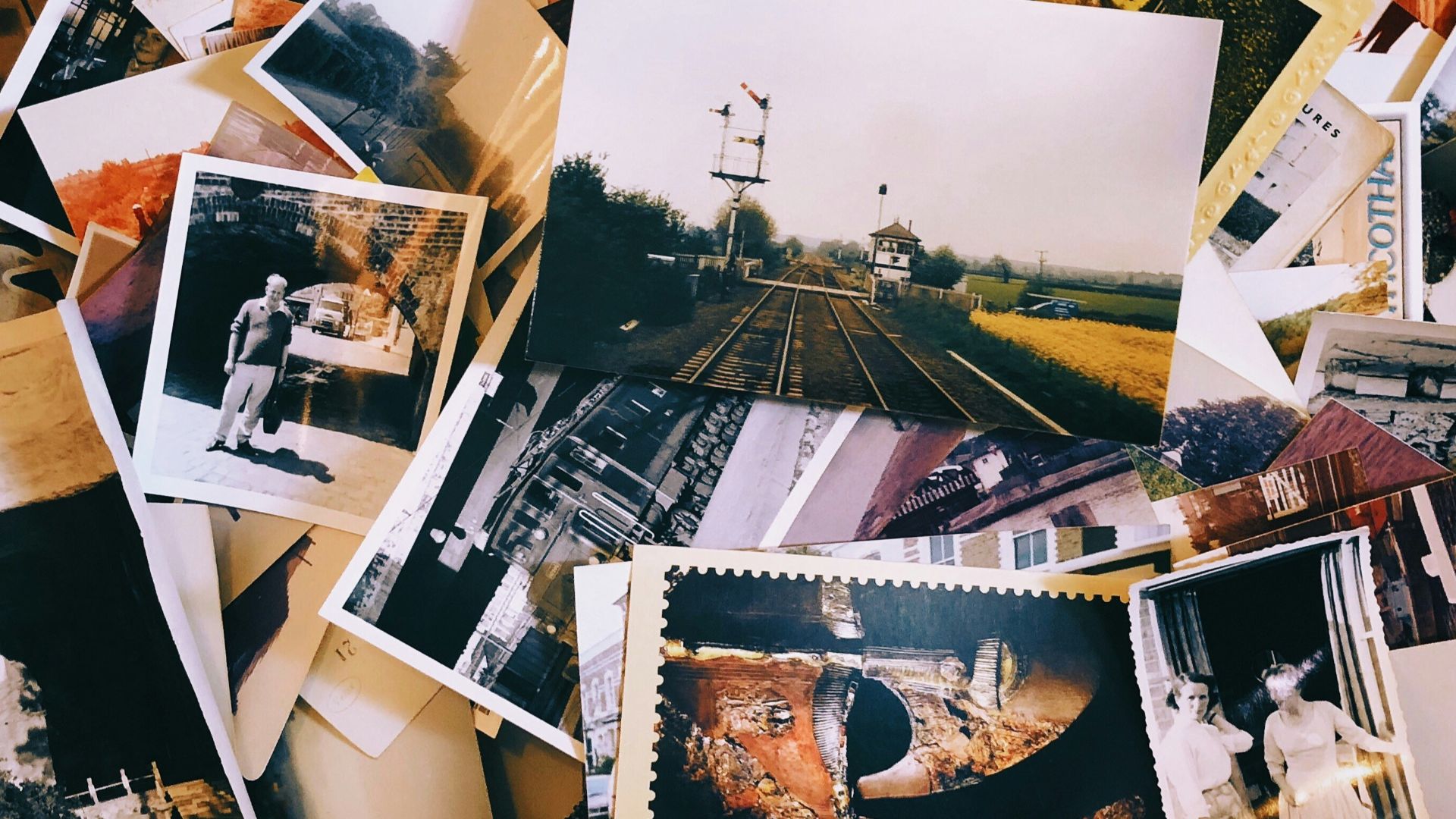 a pile of old photos and postcards sitting on top of each other