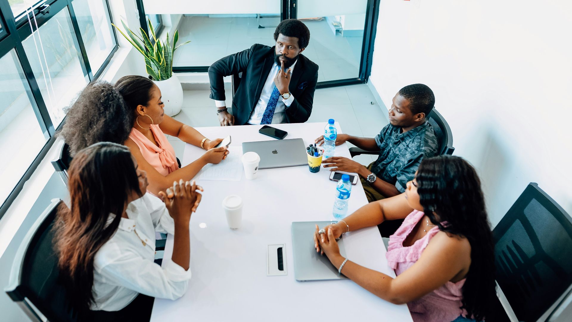A group of people sitting around a white table