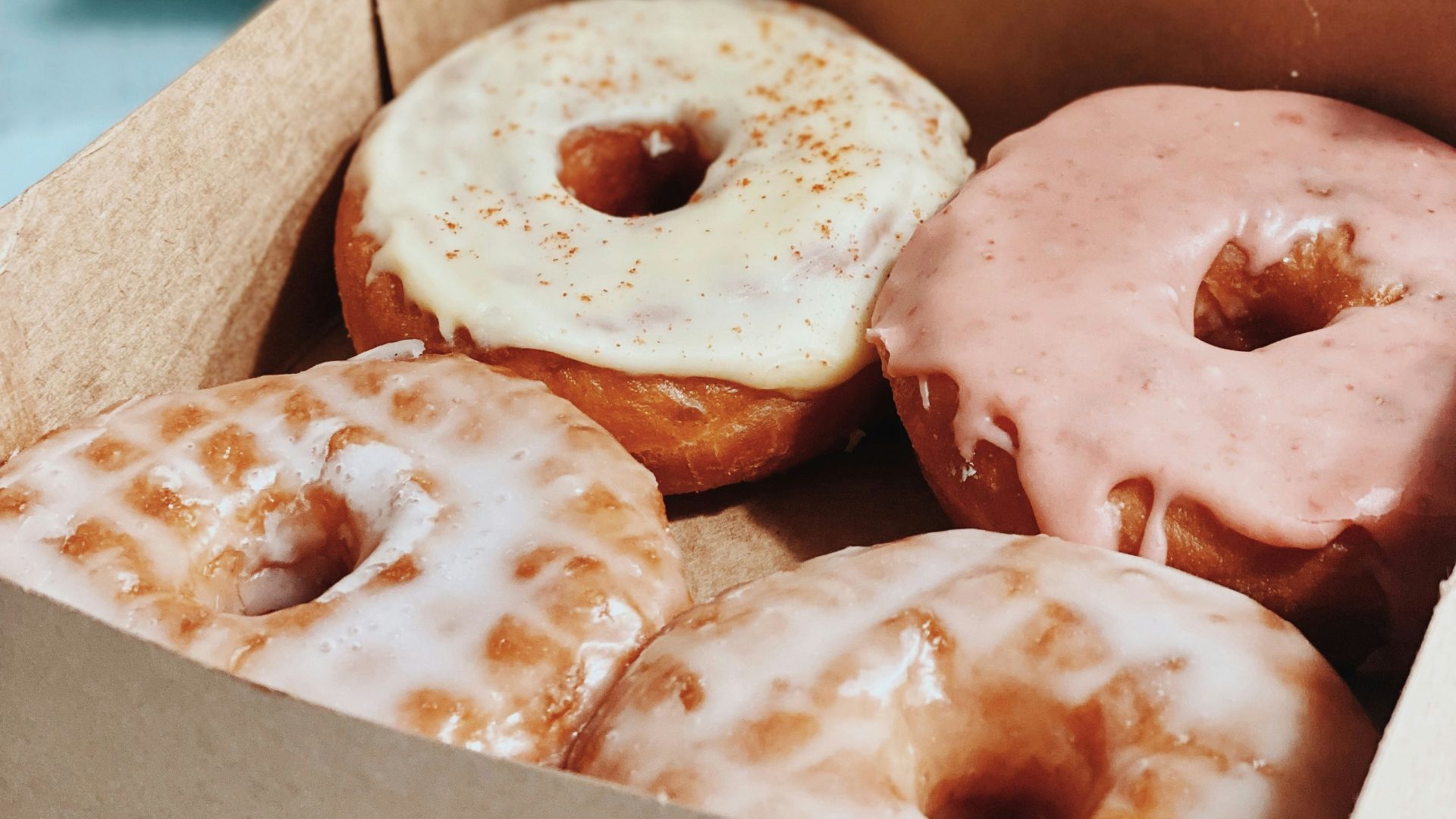 brown and white doughnuts in box