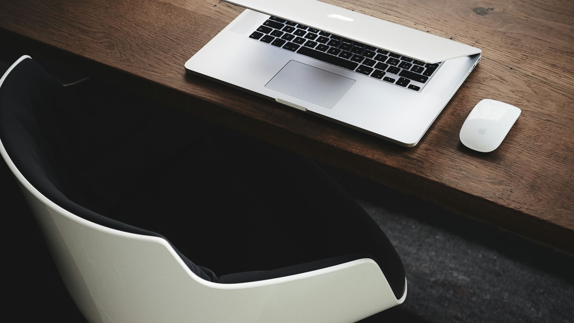 Apple MacBook beside computer mouse on table