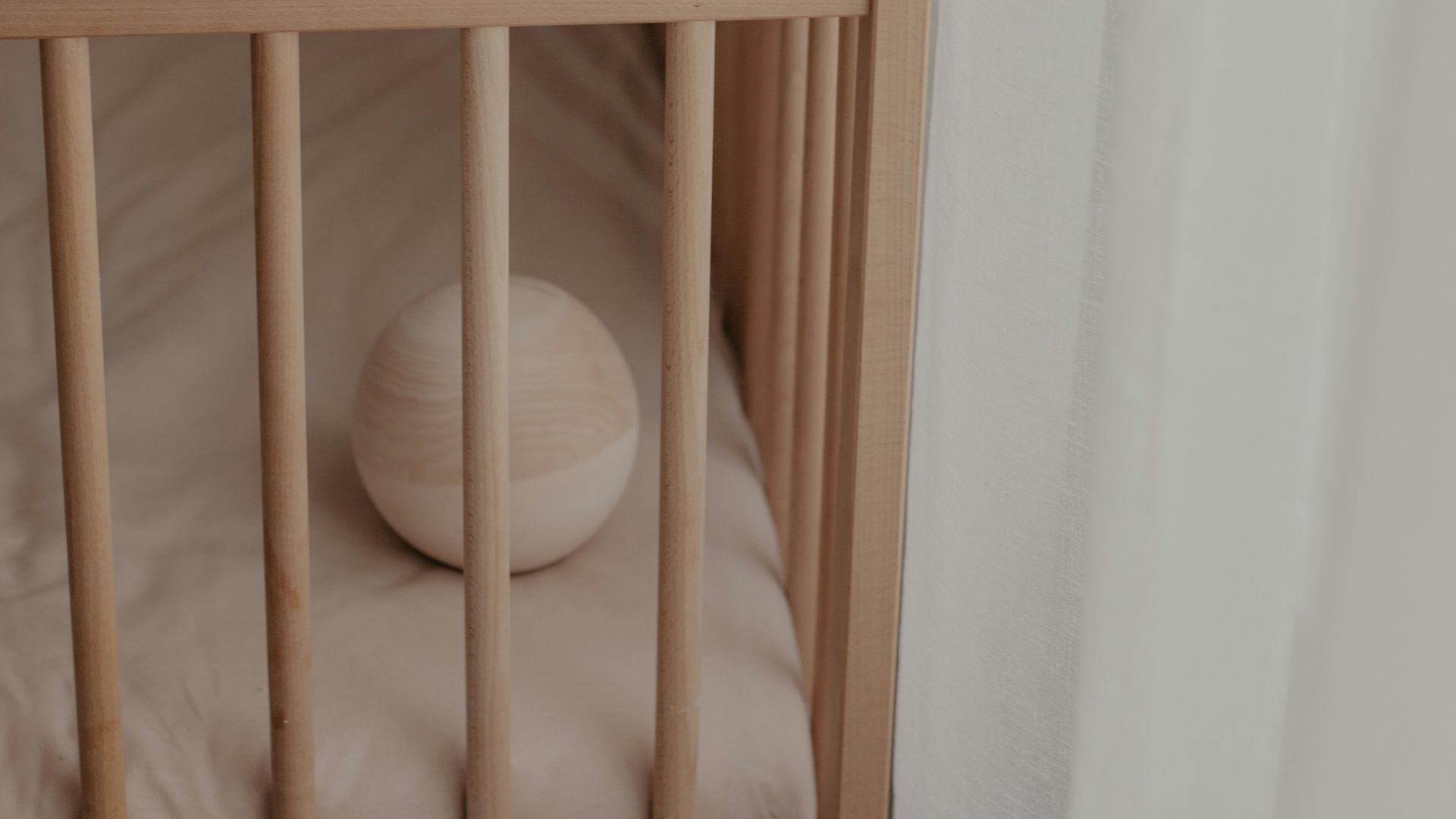 a crib with a white pillow on top of it