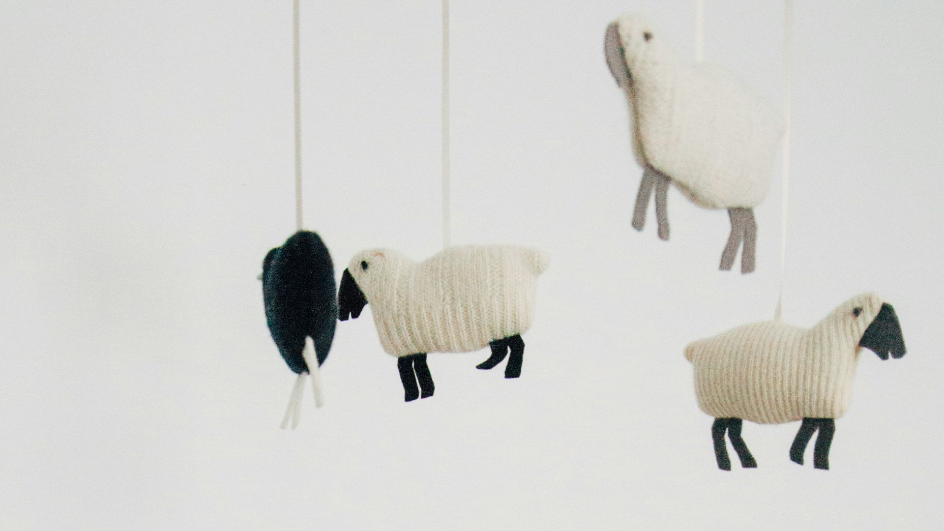crib with sheep pillow and crib mobile
