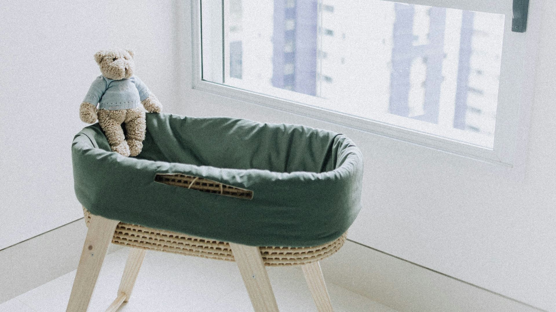 woman in green sweater lying on bed