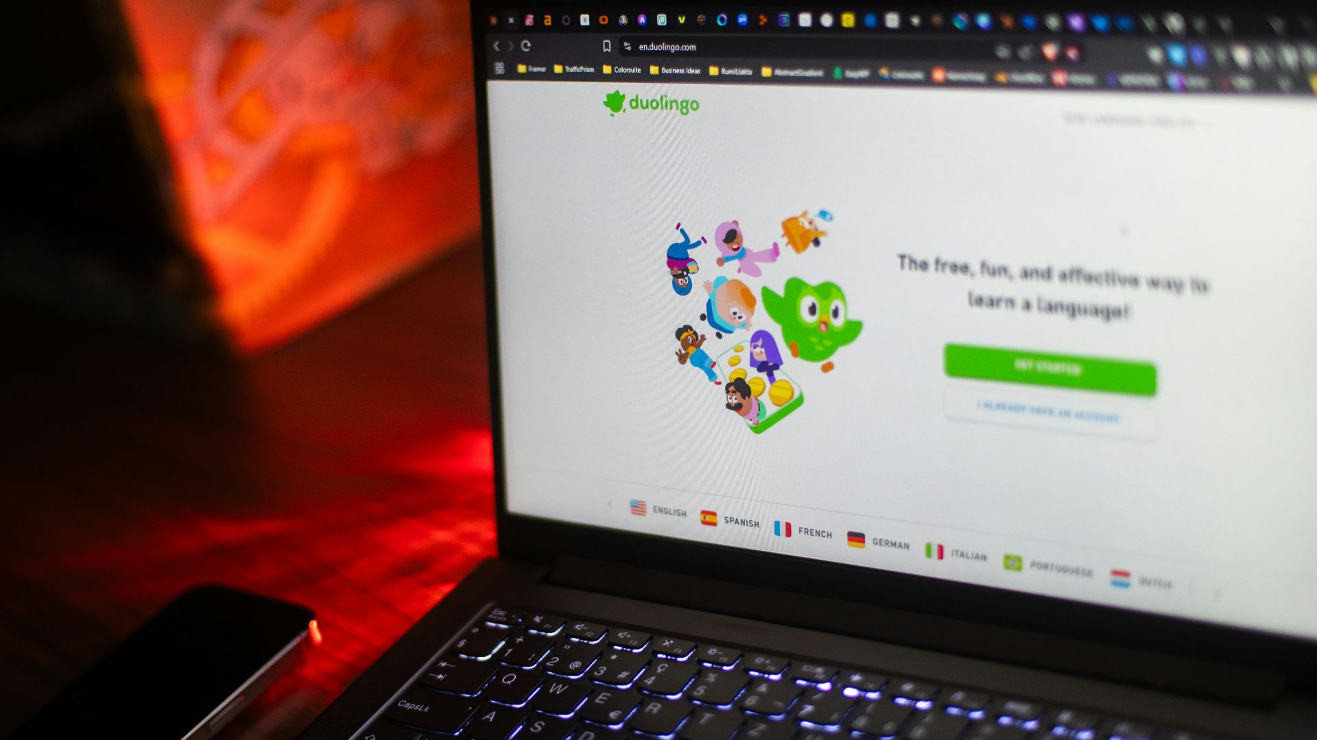 A laptop displays the duolingo homepage.