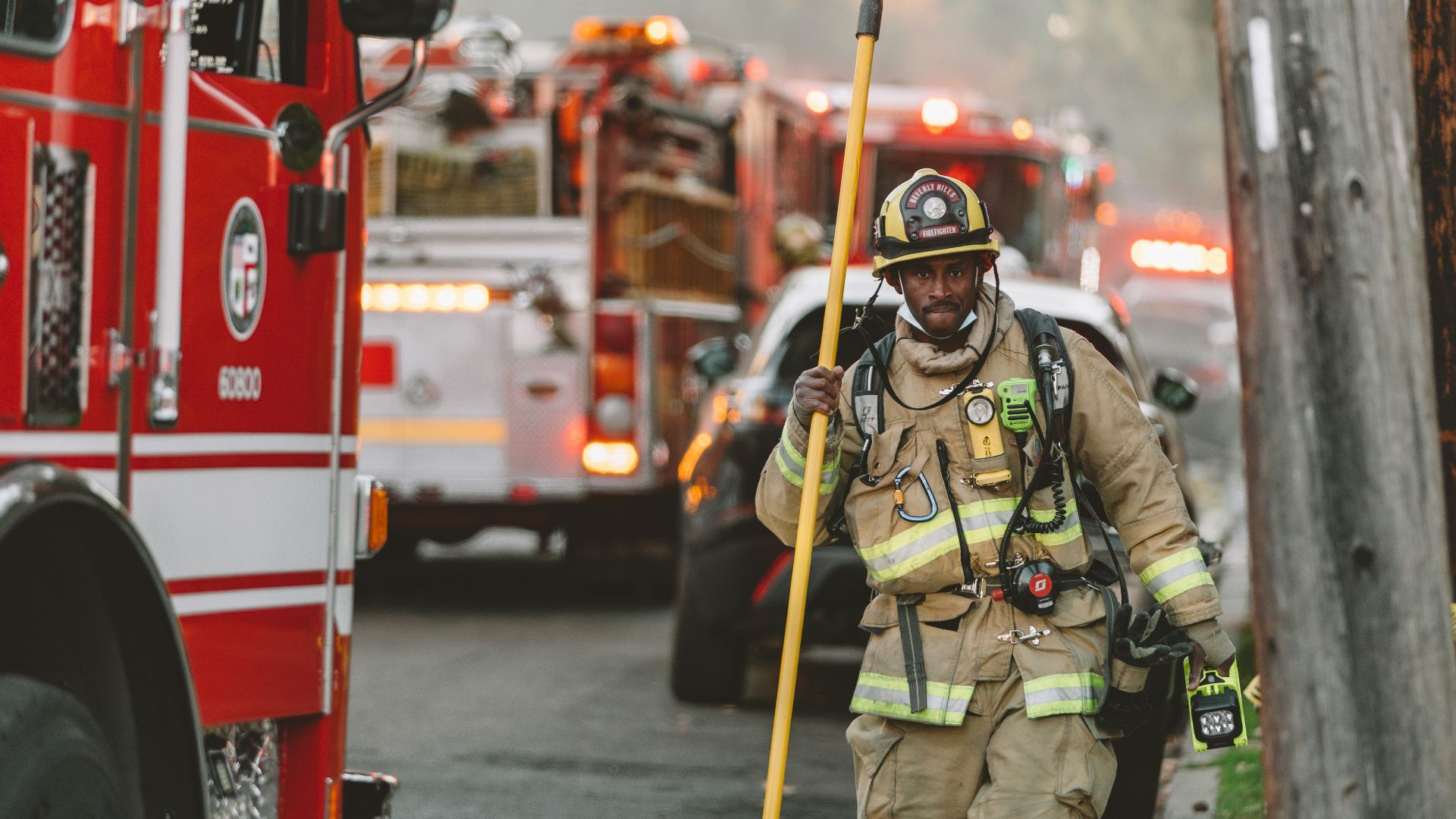 man in green and brown camouflage uniform standing near red bus during daytime