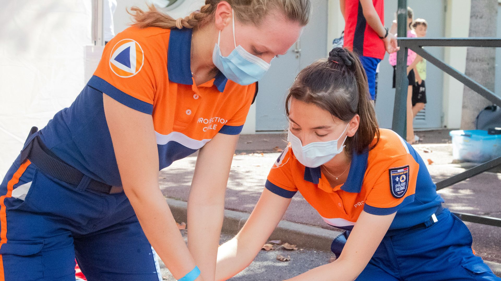 woman in blue t-shirt and blue pants holding baby