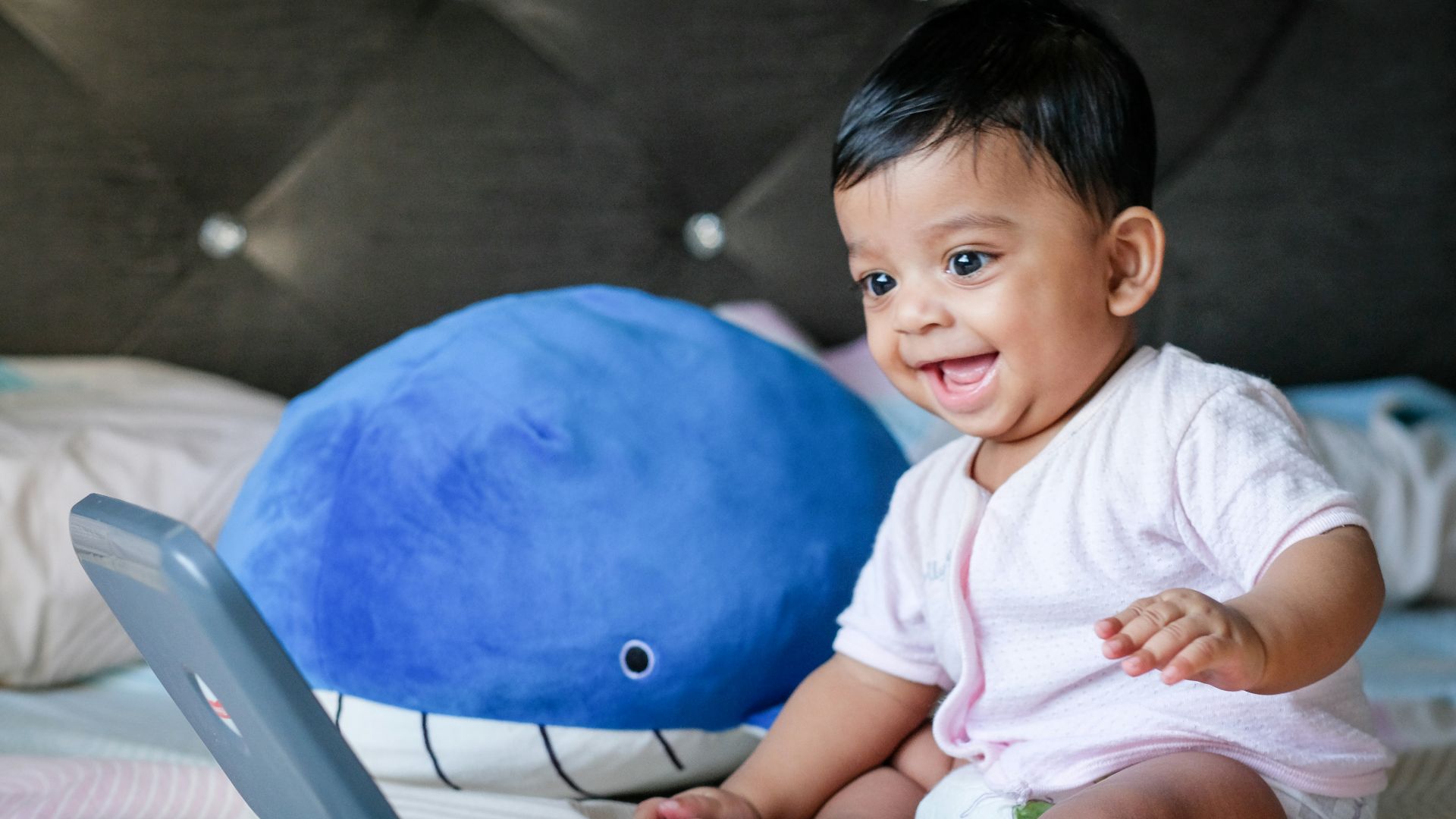 boy in white shirt sitting on blue ball