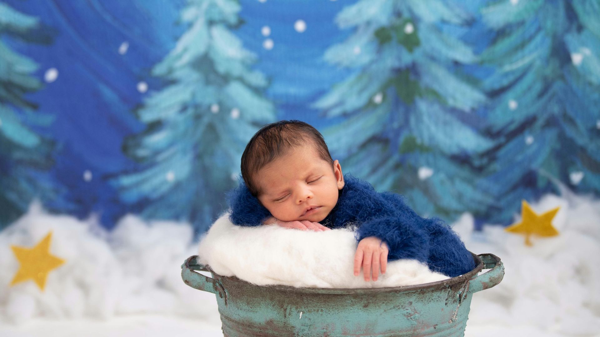 baby in white bucket on snow covered ground