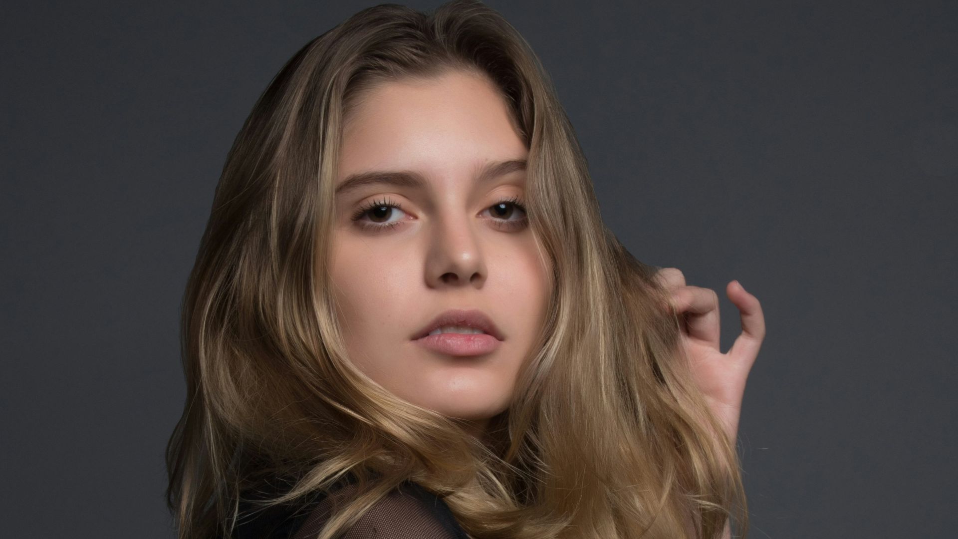 woman holding heft long blonde hair