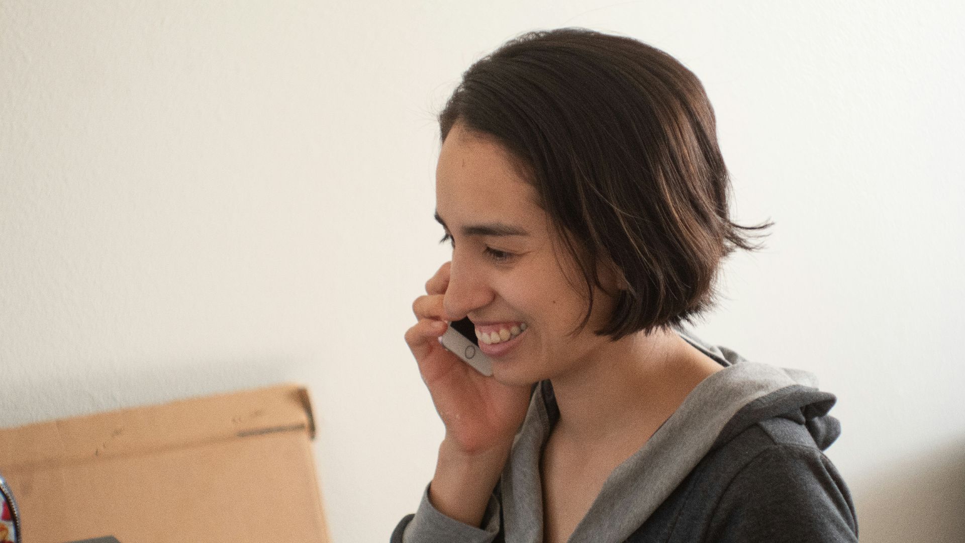 woman in gray hoodie smiling