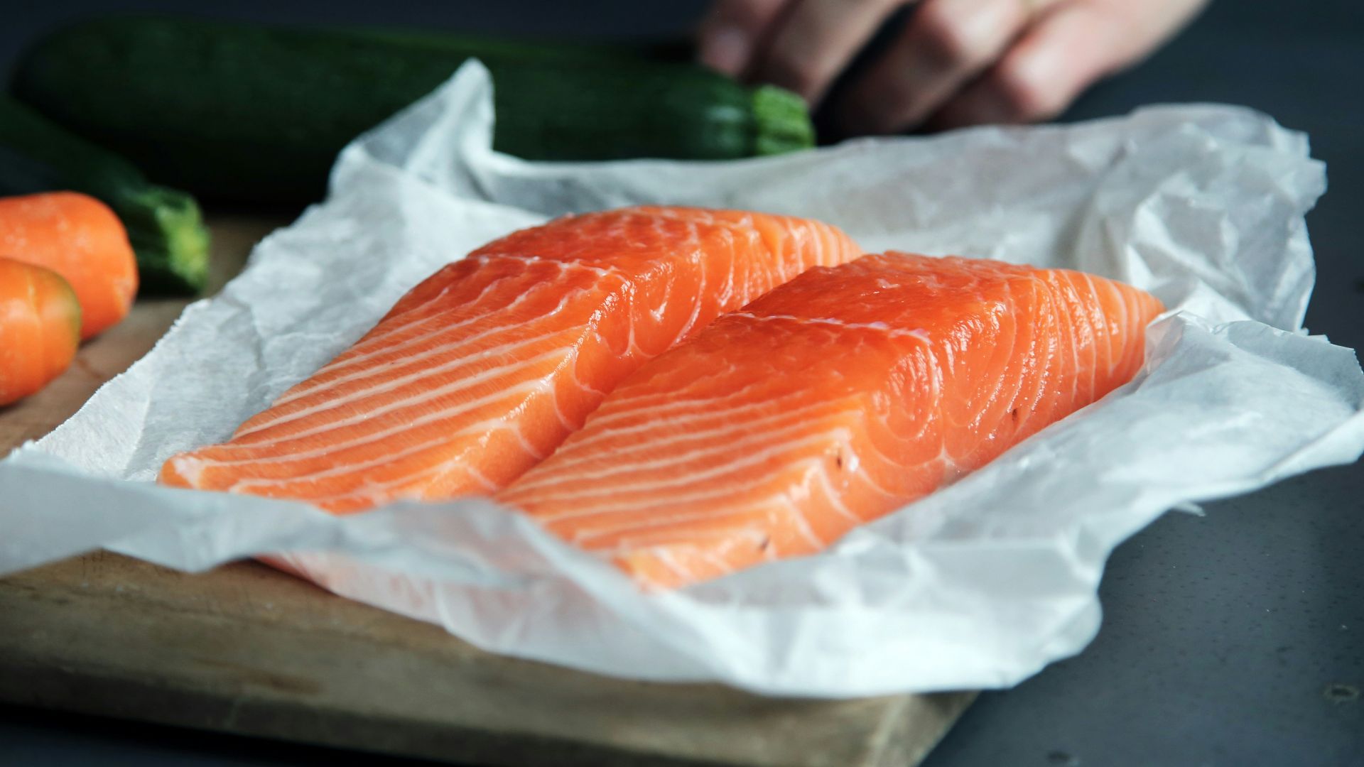 raw fish meat on brown chopping board