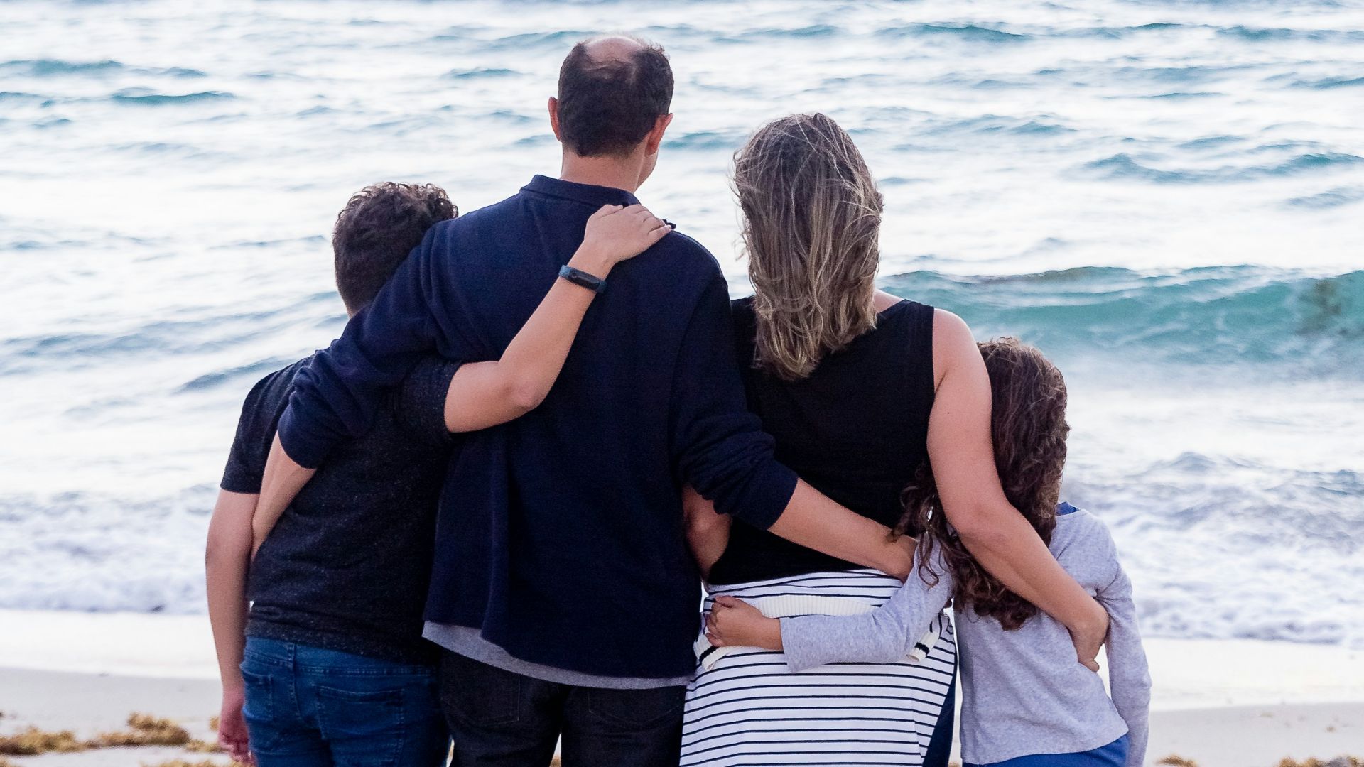 a family of four on a beach