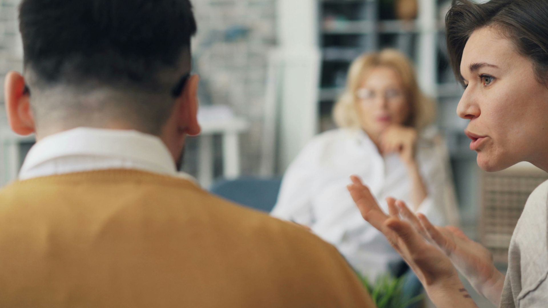 a woman talking to a man at a table