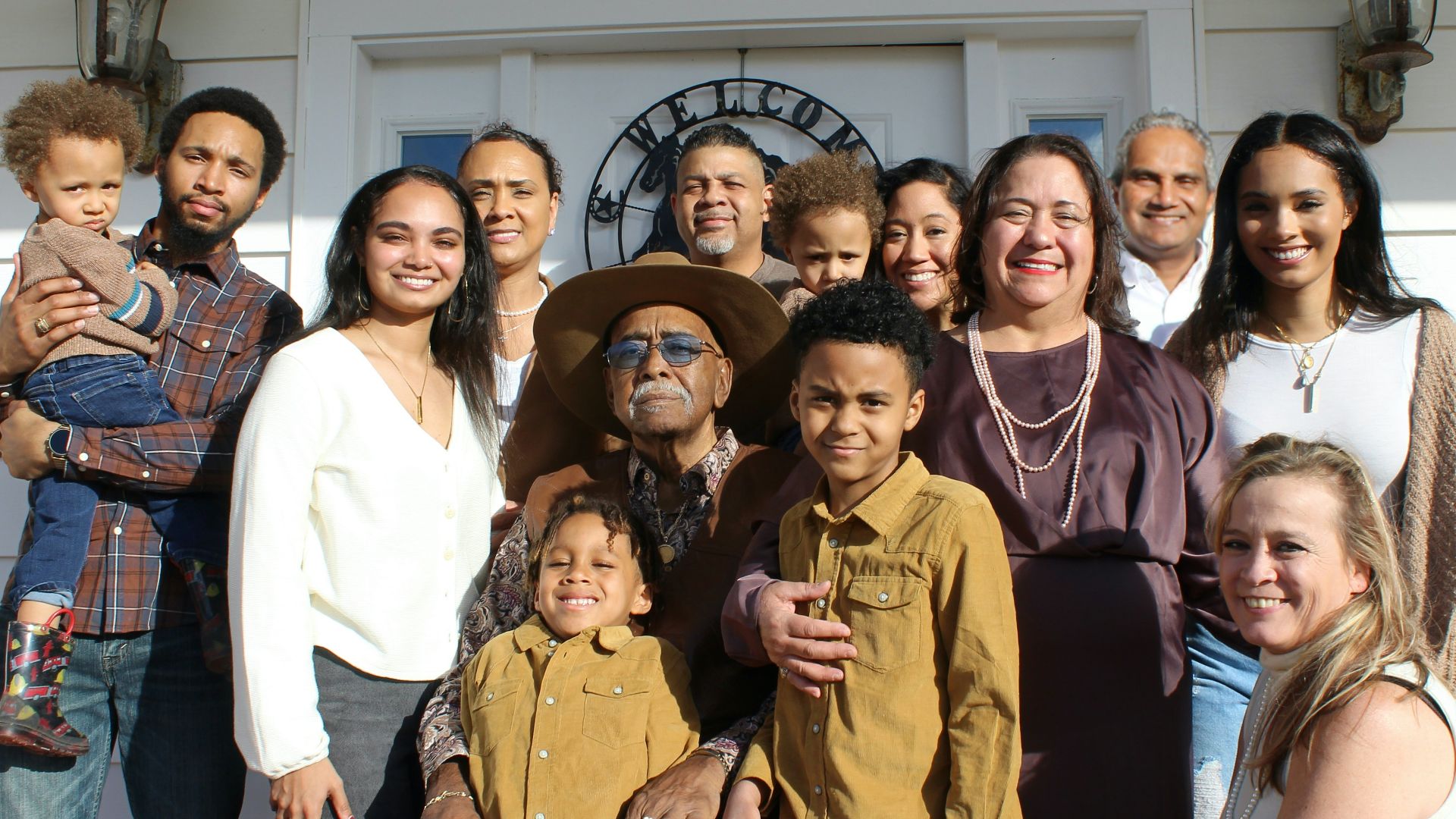 group of people standing near white building