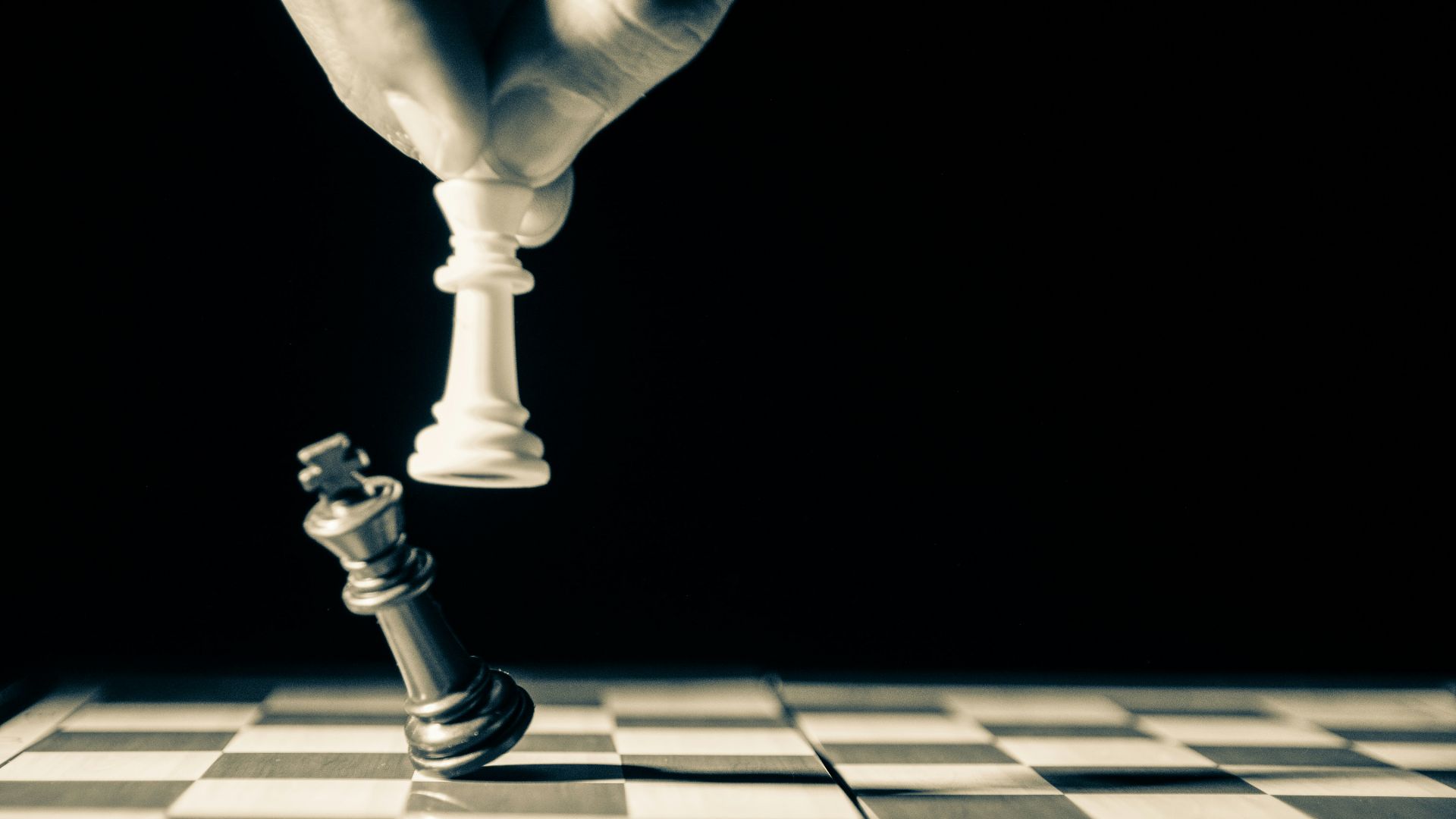 grayscale photo of person holding glass