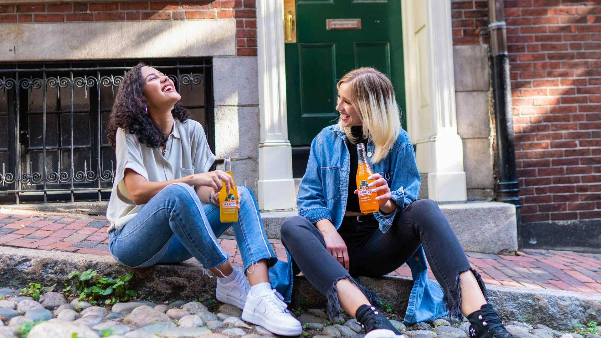 2 women sitting on green grass lawn during daytime