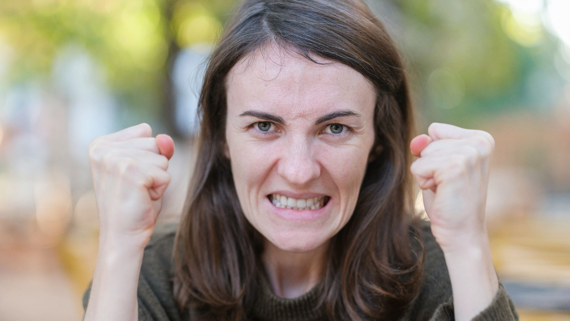 a woman holding her fists up in the air