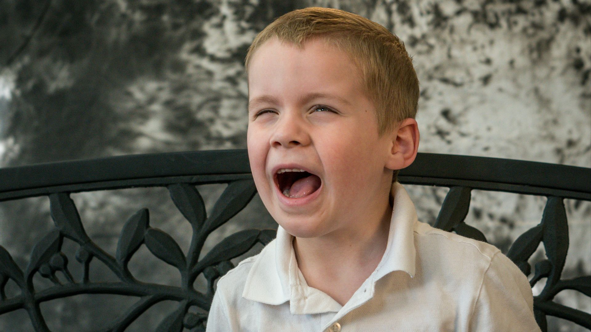 shallow focus photo of boy in white button-up shirt