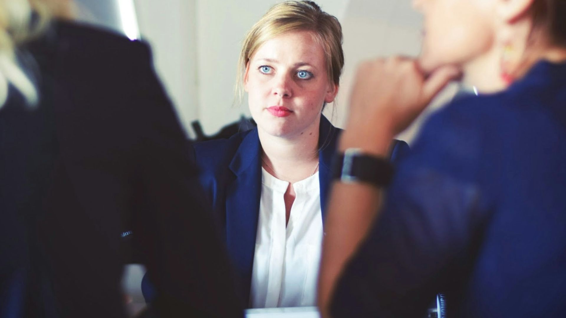 three women sitting beside table