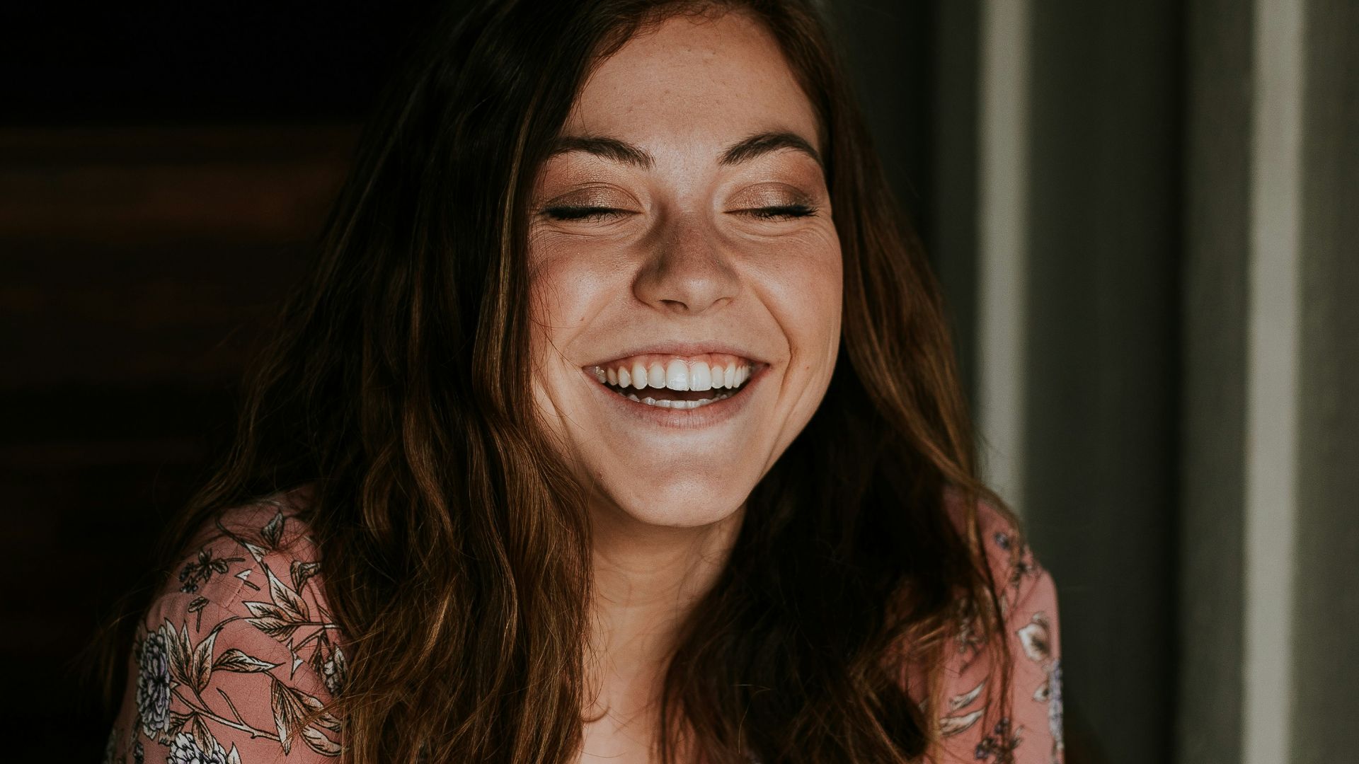 woman sitting on wooden stair smiling