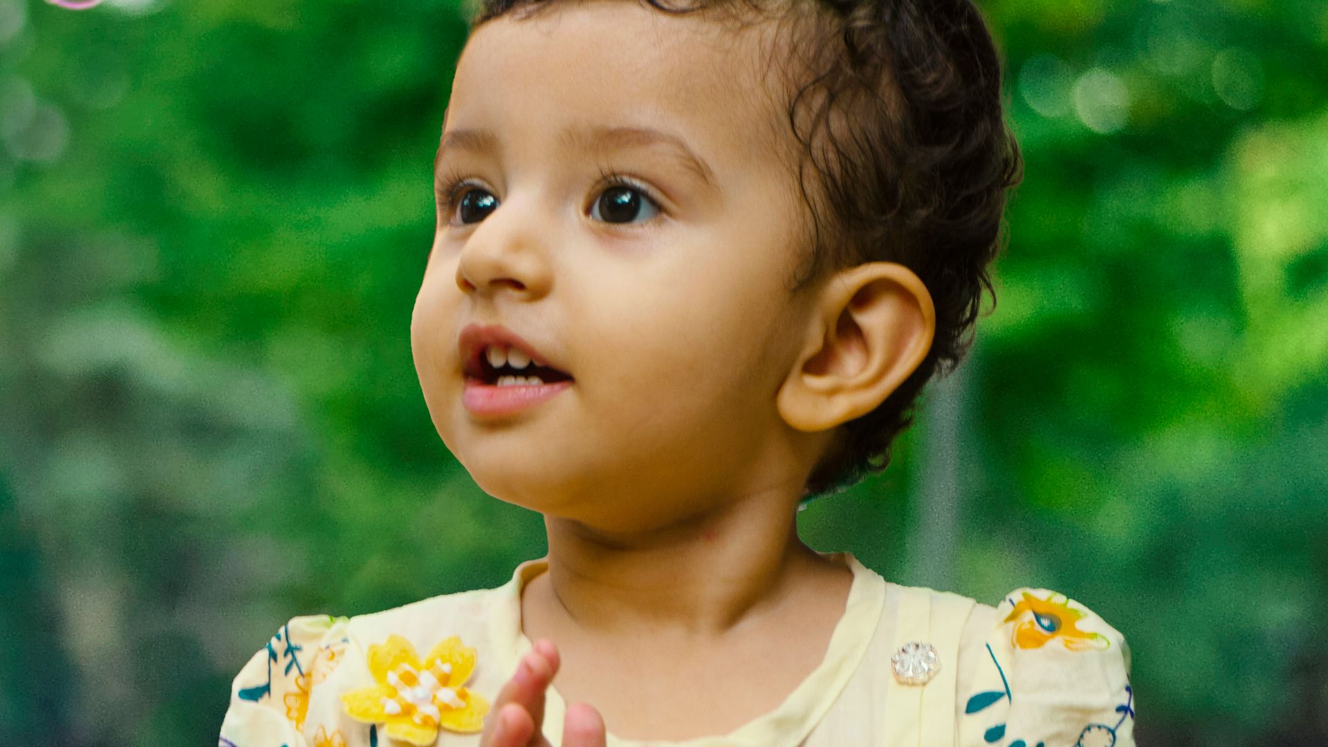 a baby in a yellow dress