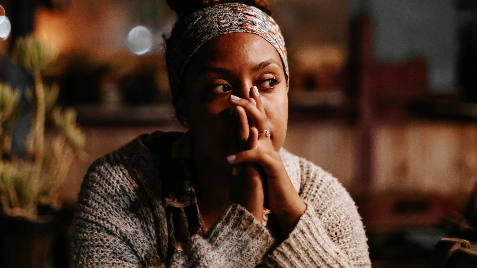 man in black and white sweater sitting on chair