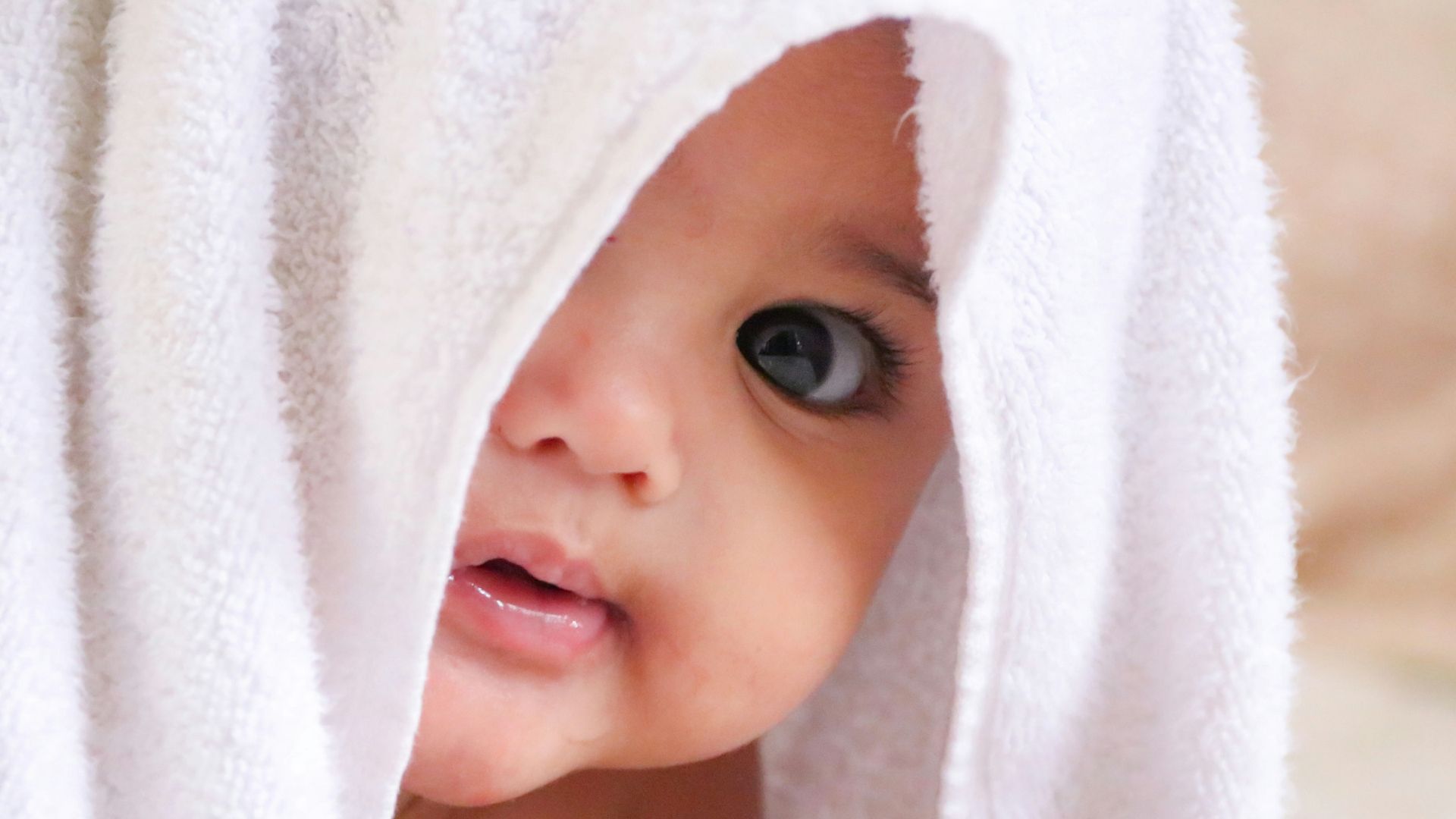 baby doll covered with white towel