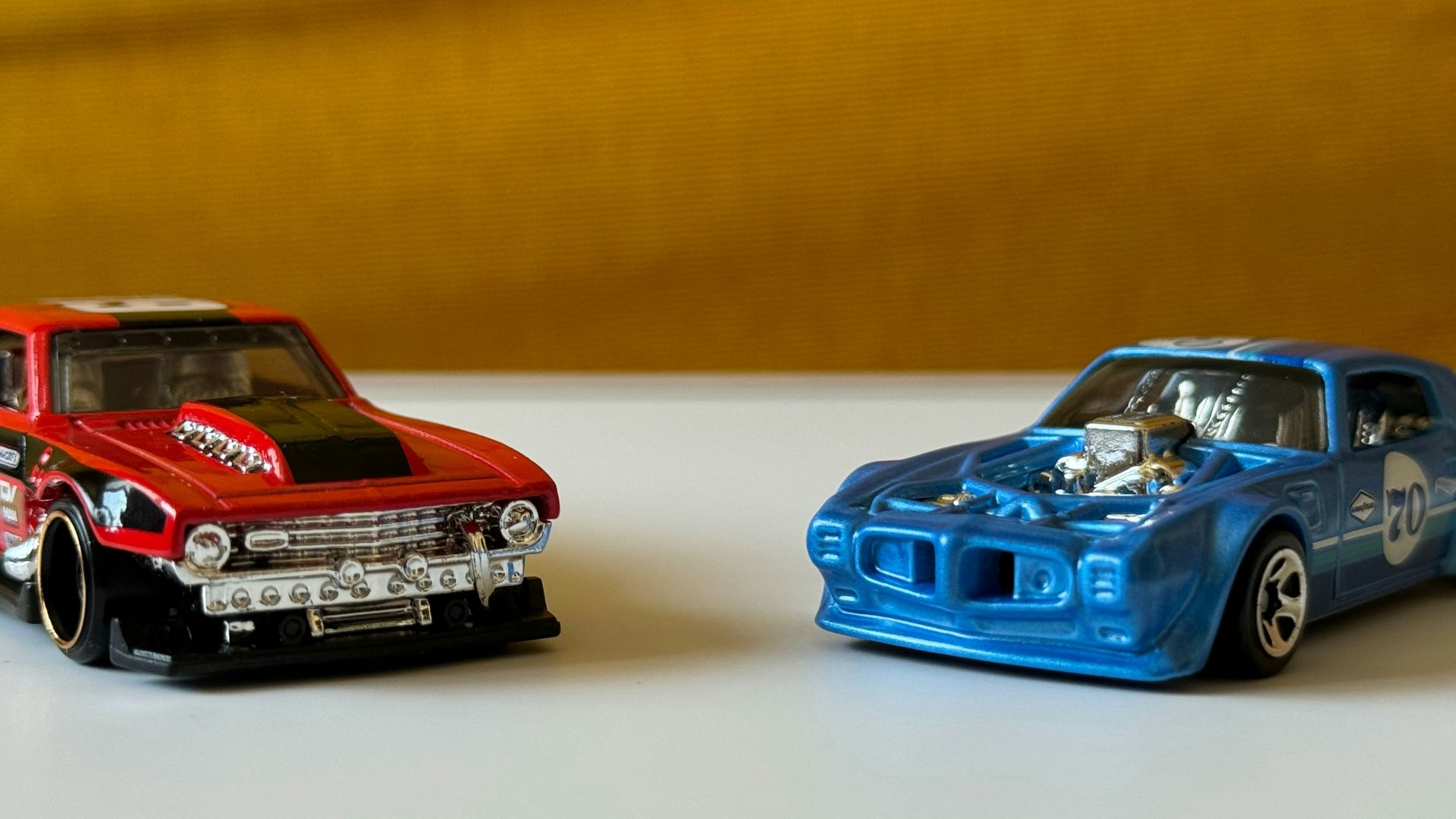 a couple of toy cars sitting on top of a table