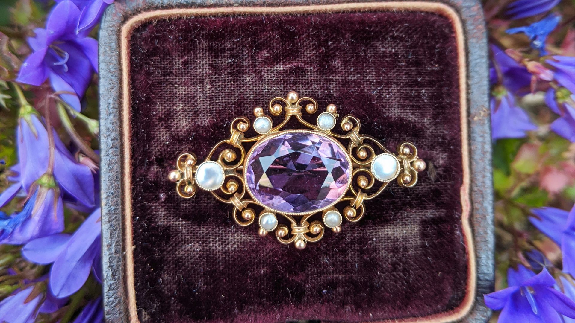 gold and silver round analog watch on black and purple case