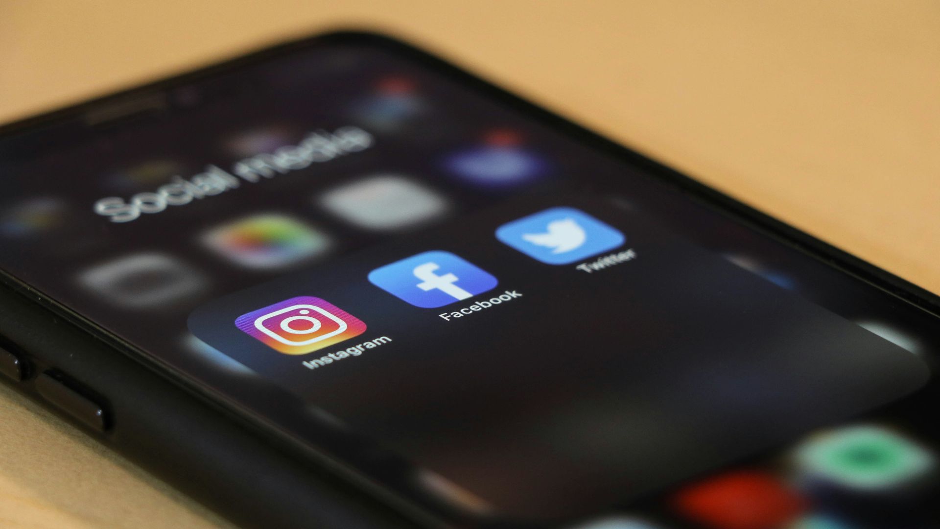 black iphone 4 on brown wooden table