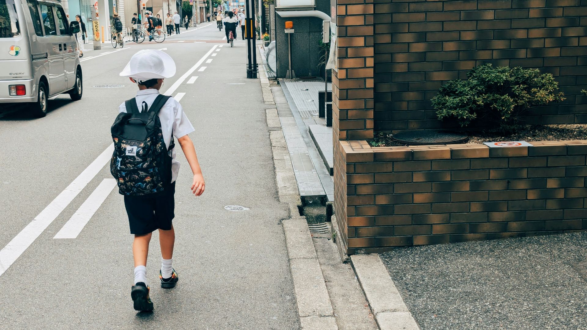A person walking down a street with a backpack