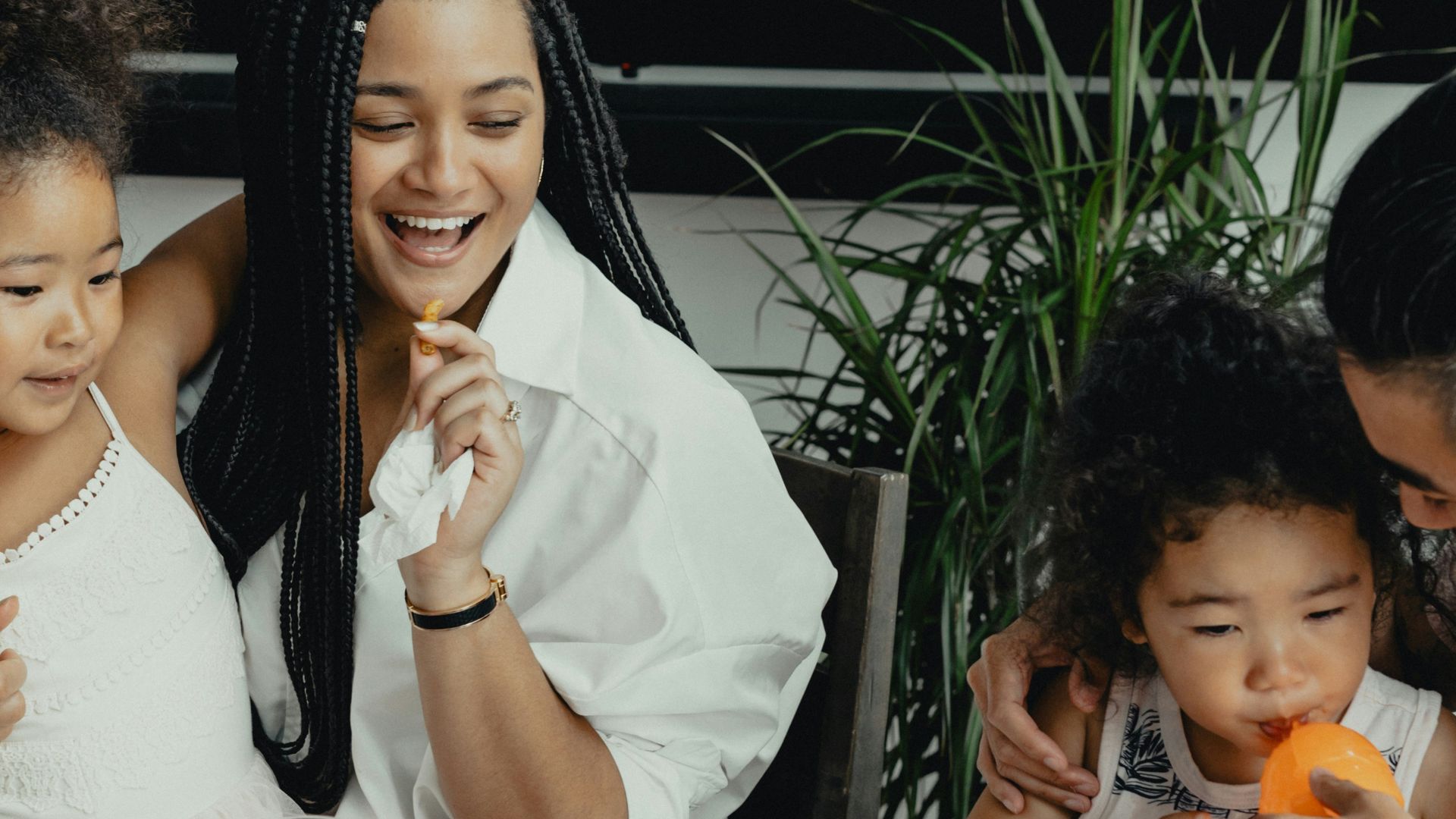 woman in white sleeveless dress sitting beside woman in white sleeveless dress