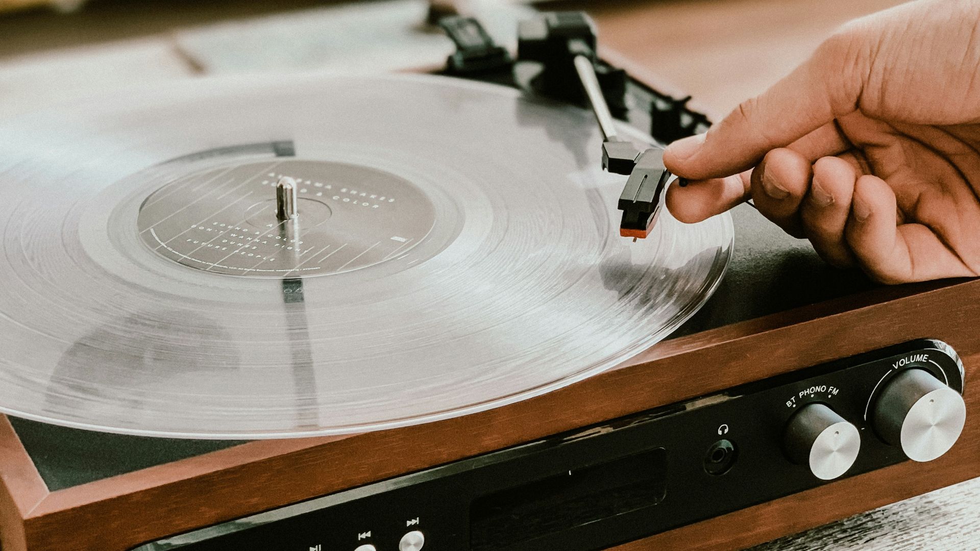 person playing record on Victrola turntable