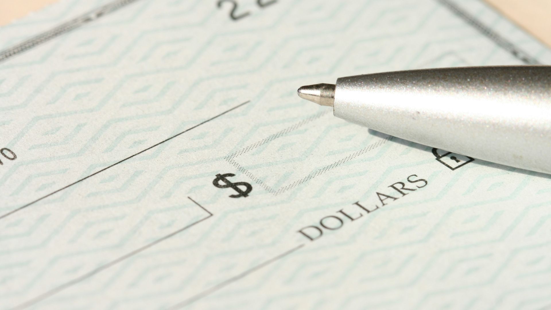 a pen sitting on top of a cheque paper