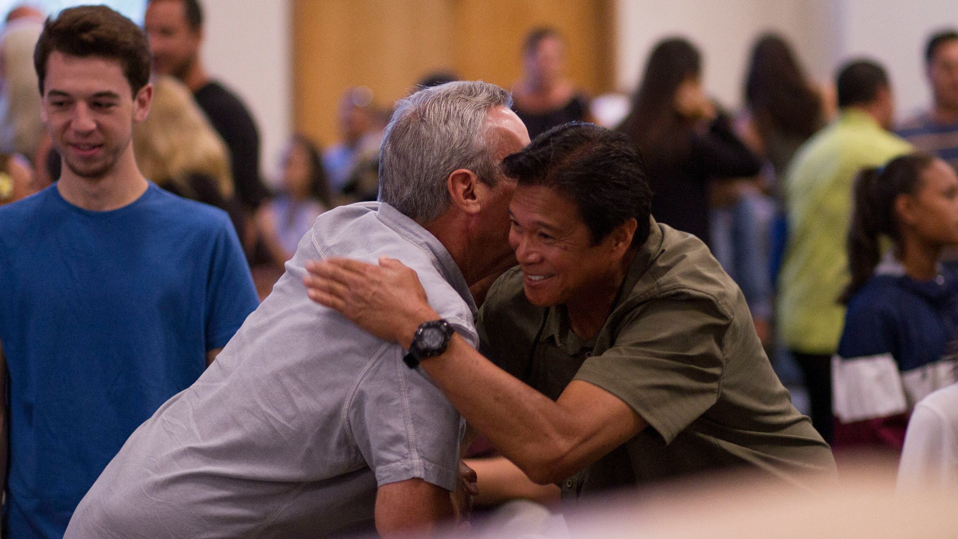 two men hugging on focus photography