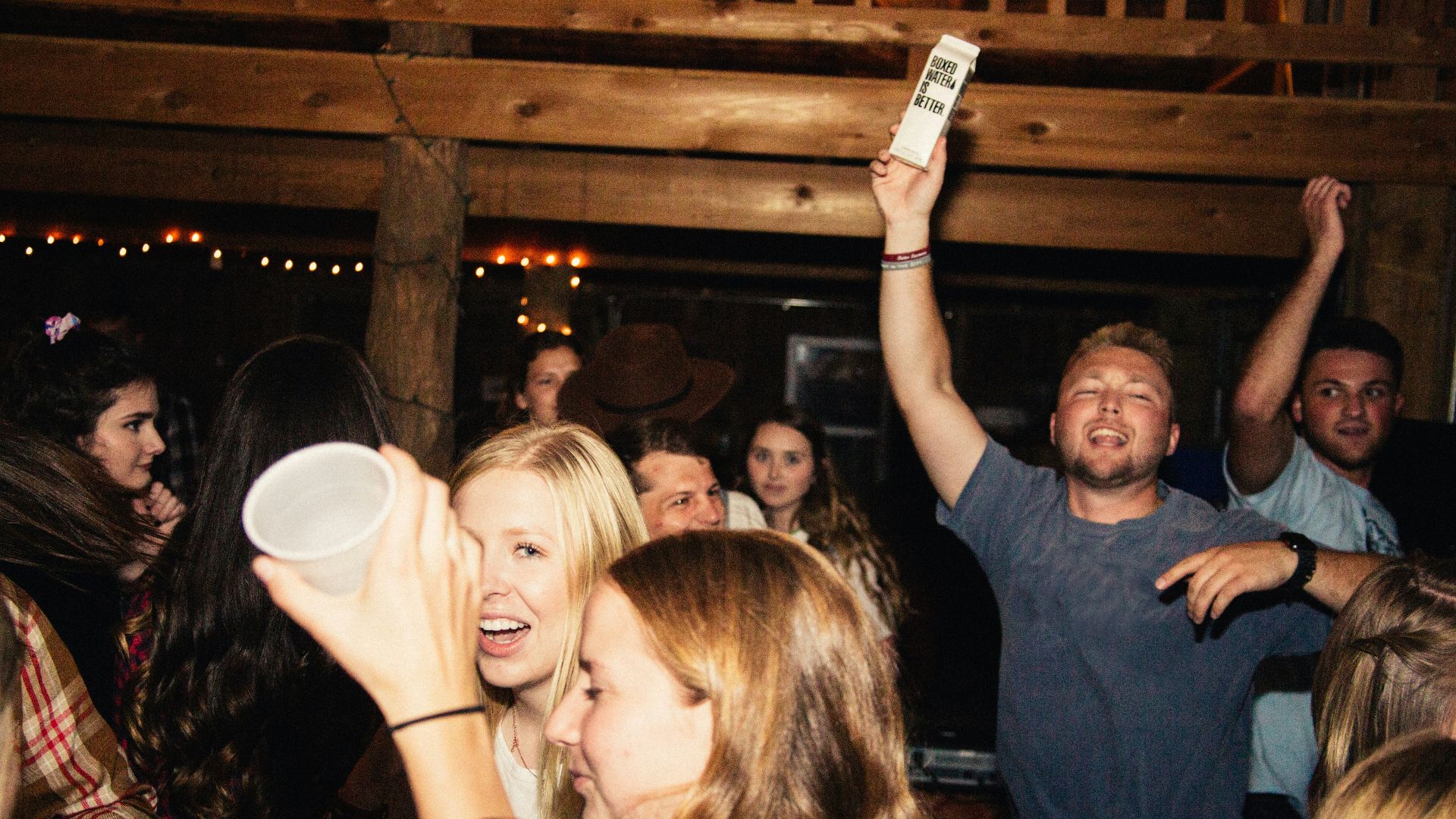 man in black crew neck t-shirt holding white ceramic mug