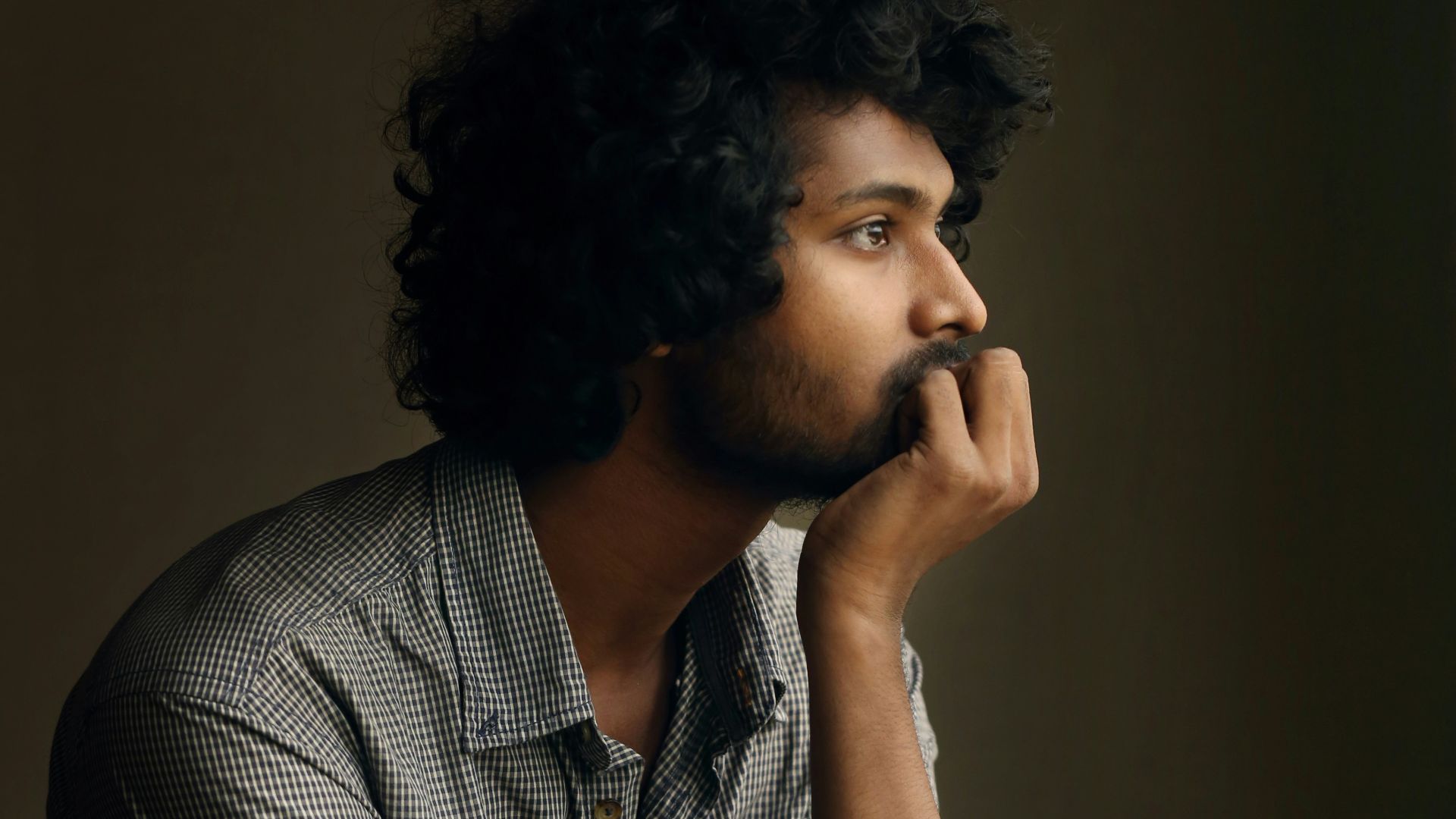 man in gray and white checkered dress shirt