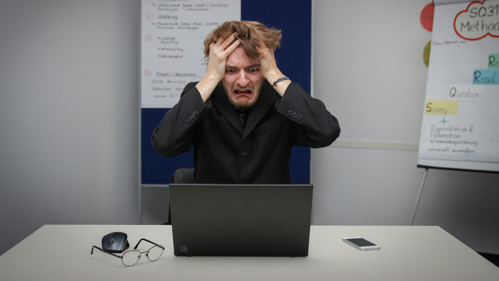A man sitting in front of a laptop computer