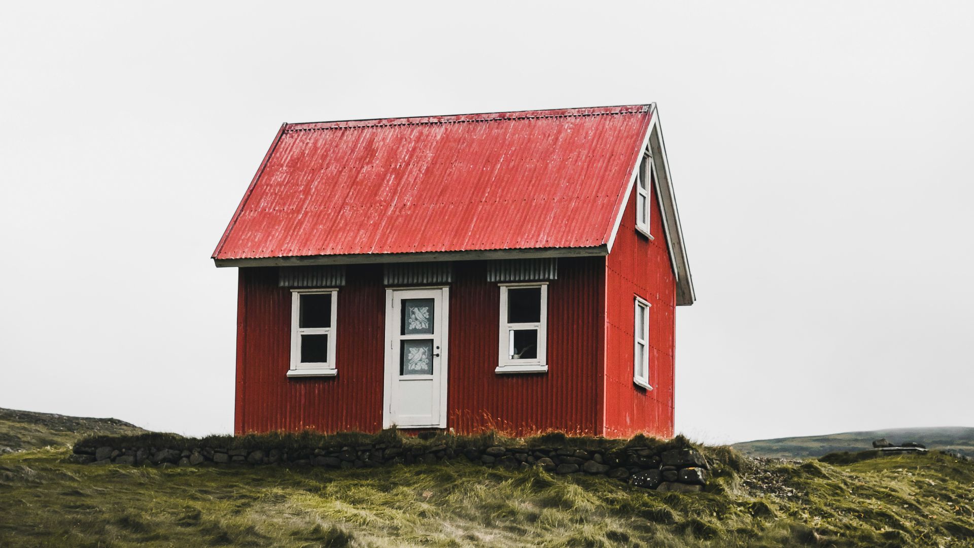 red and white house surround green grass field