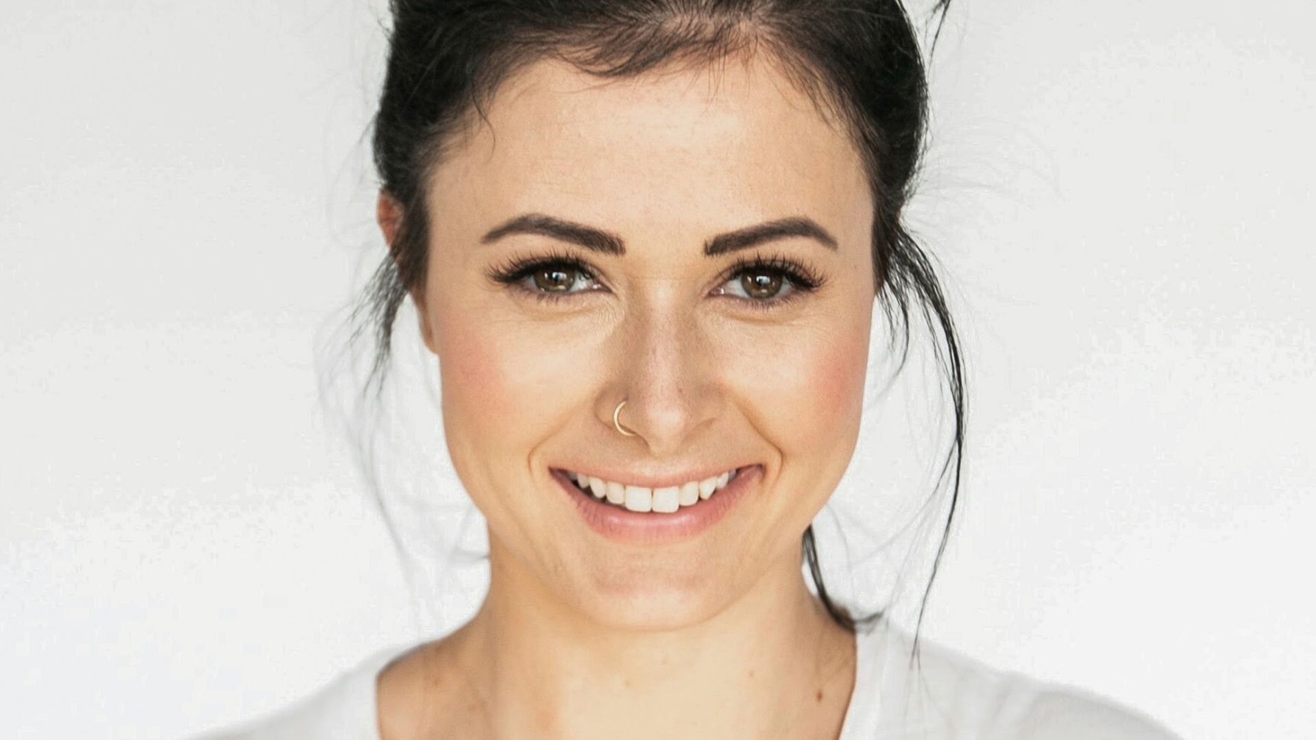 woman in white crew neck shirt smiling