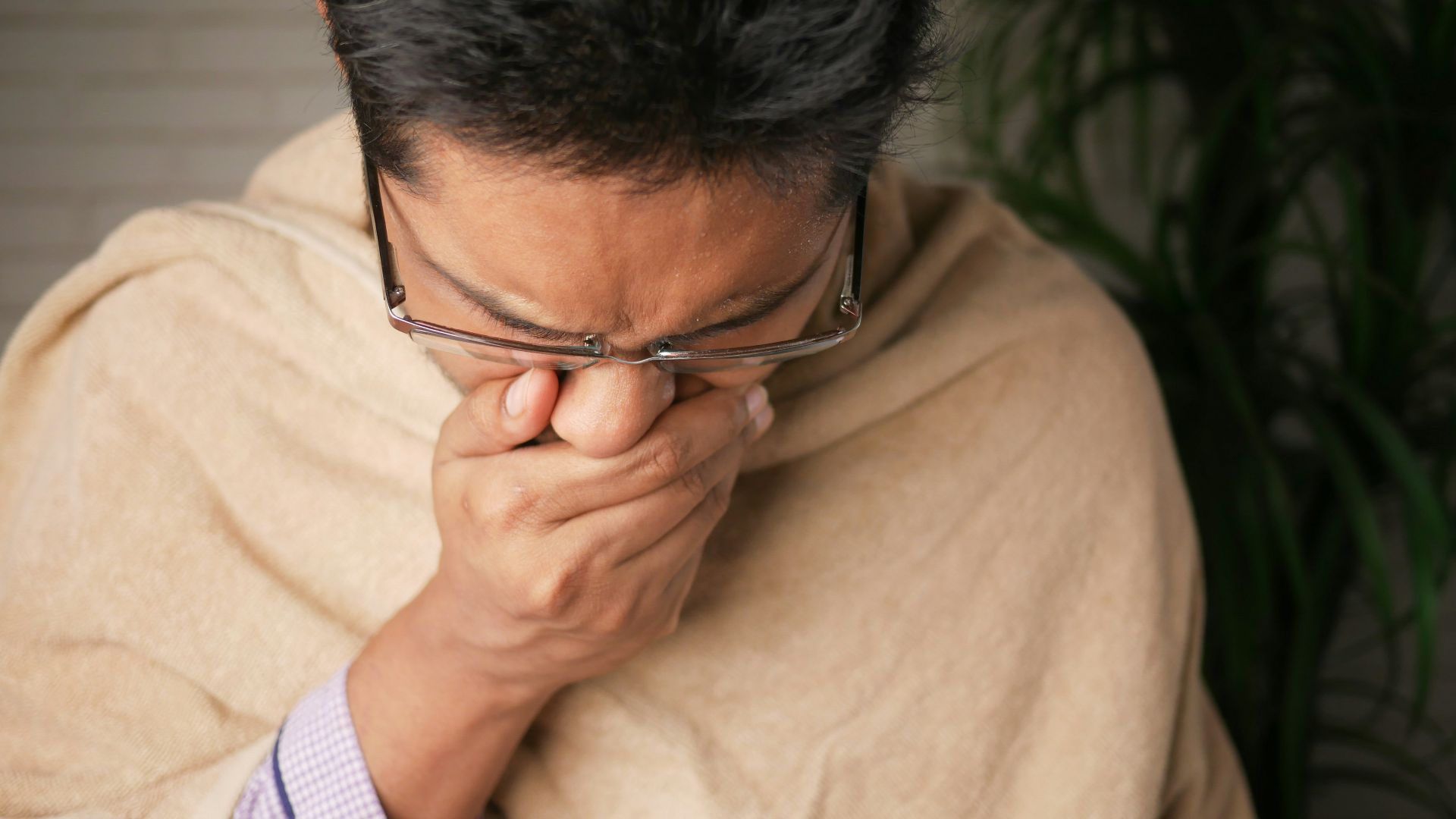 man in brown sweater wearing black framed eyeglasses